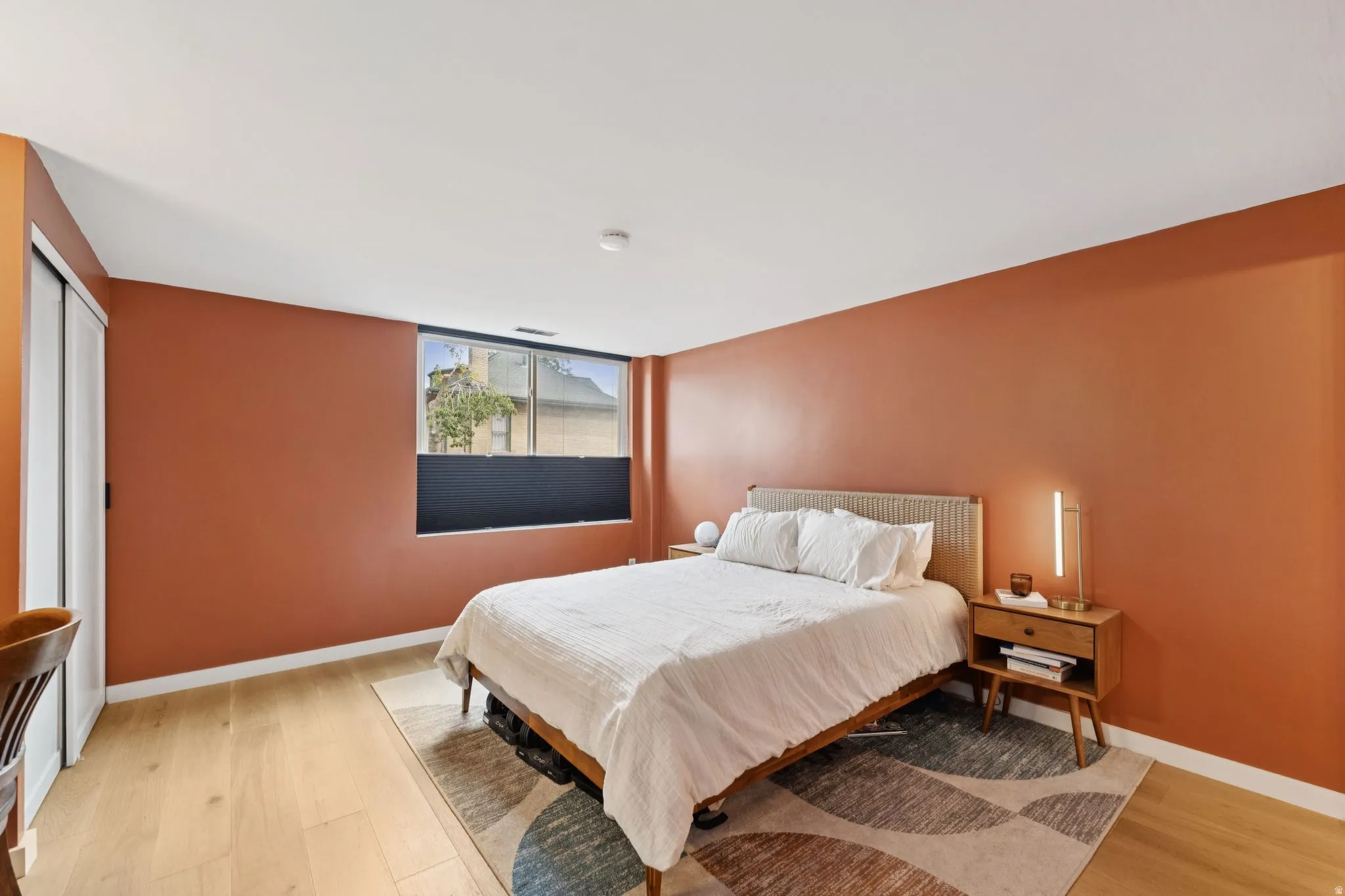 Primary Bedroom featuring light engineered wood flooring and baseboards