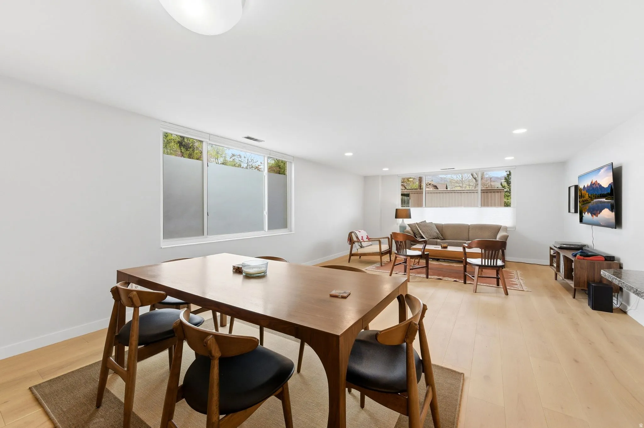 Dining area featuring light engineered flooring and recessed lighting