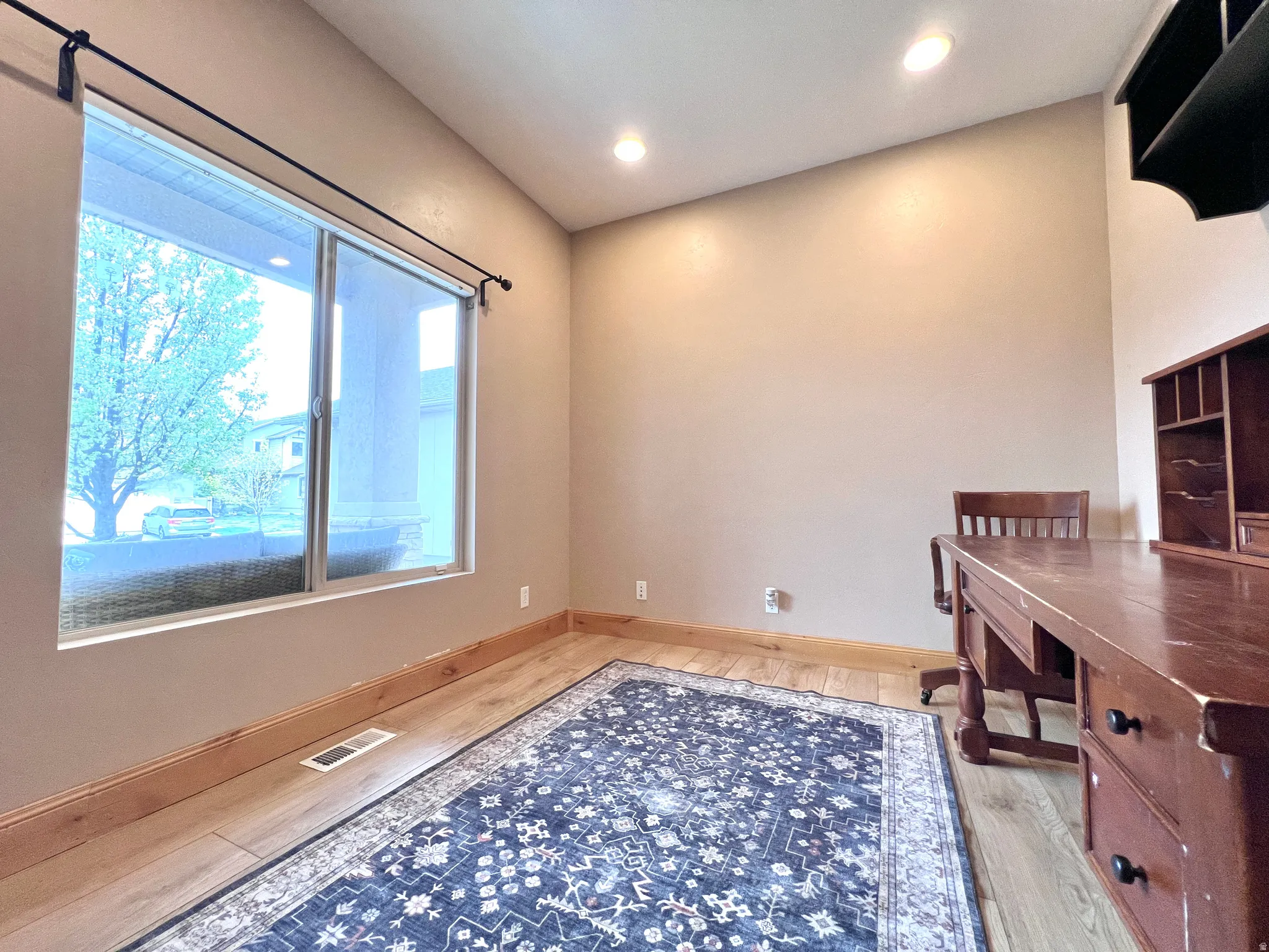 Unfurnished office with light wood-style floors and recessed lighting