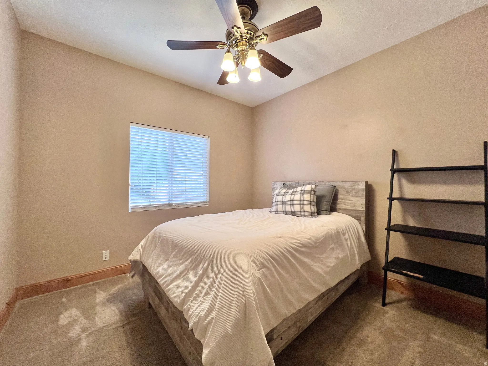 Bedroom featuring carpet flooring and ceiling fan
