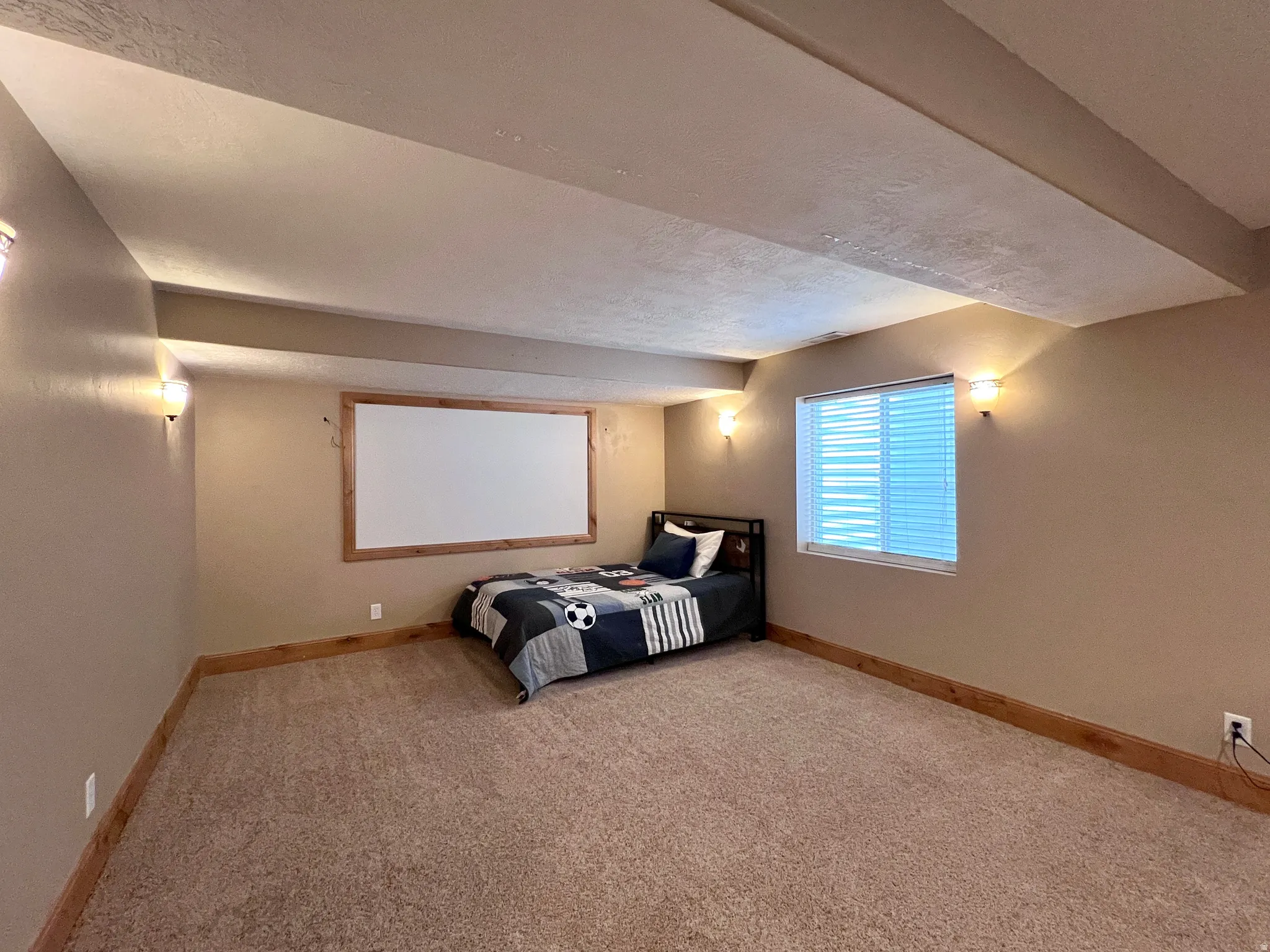 Unfurnished bedroom with baseboards and light carpet