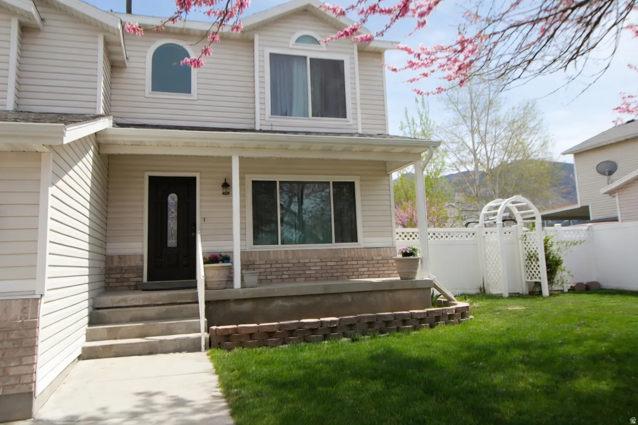 View of front of property with covered porch and brick siding