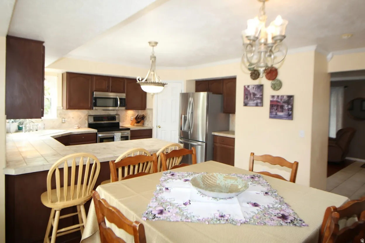 Dining room featuring a chandelier and crown molding