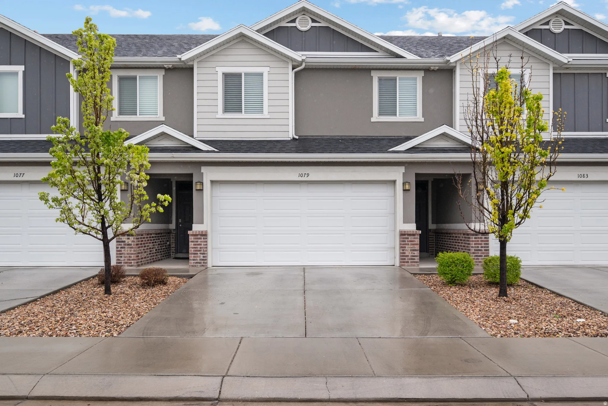 View of front of home featuring board and batten siding, brick siding, and a shingled roof