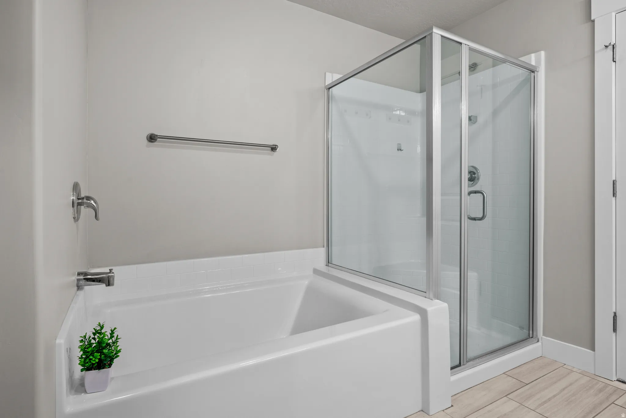 Bathroom featuring a garden tub and a stall shower