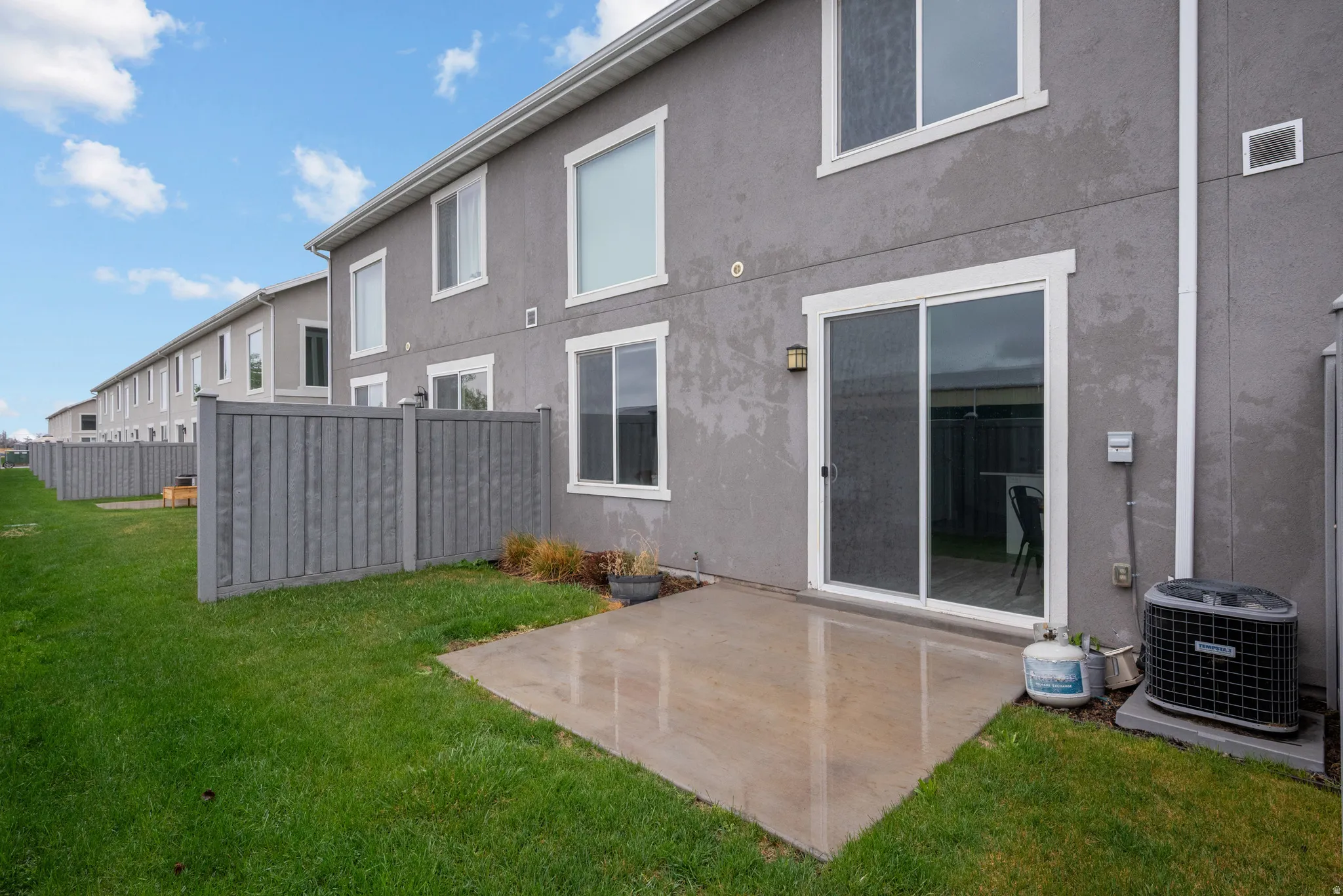 Back of property featuring a patio and stucco siding