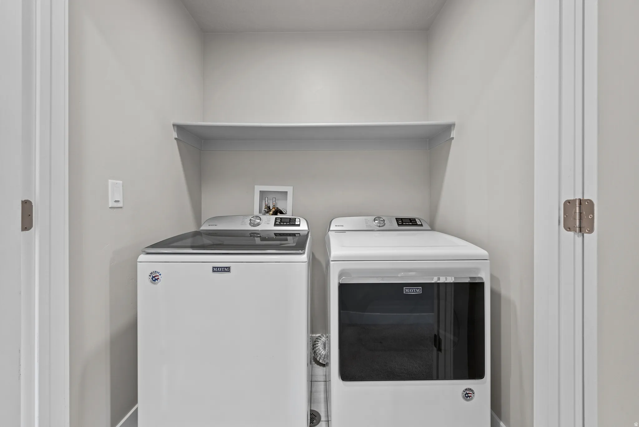 Laundry room with washing machine and clothes dryer