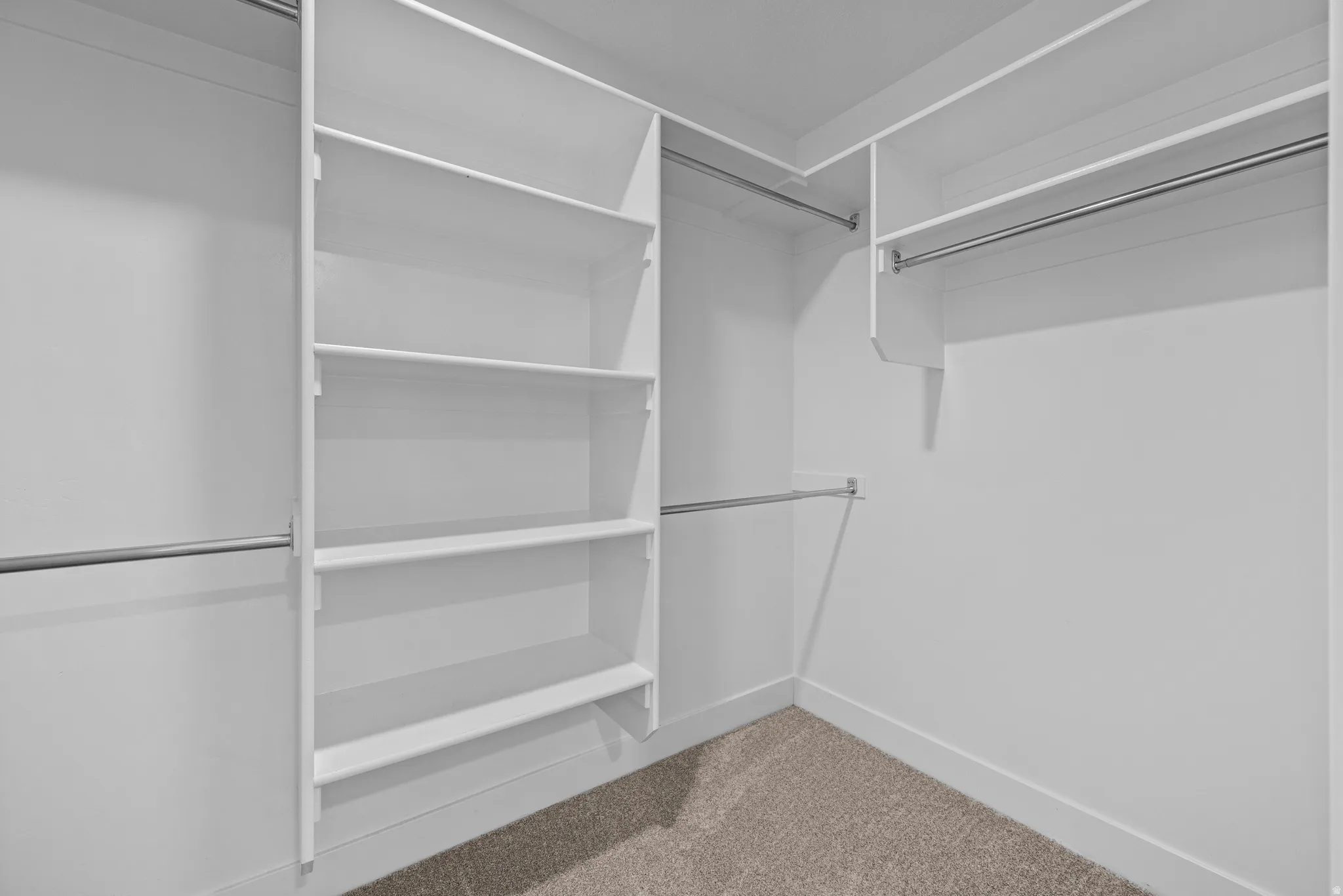 Walk in closet with light carpet