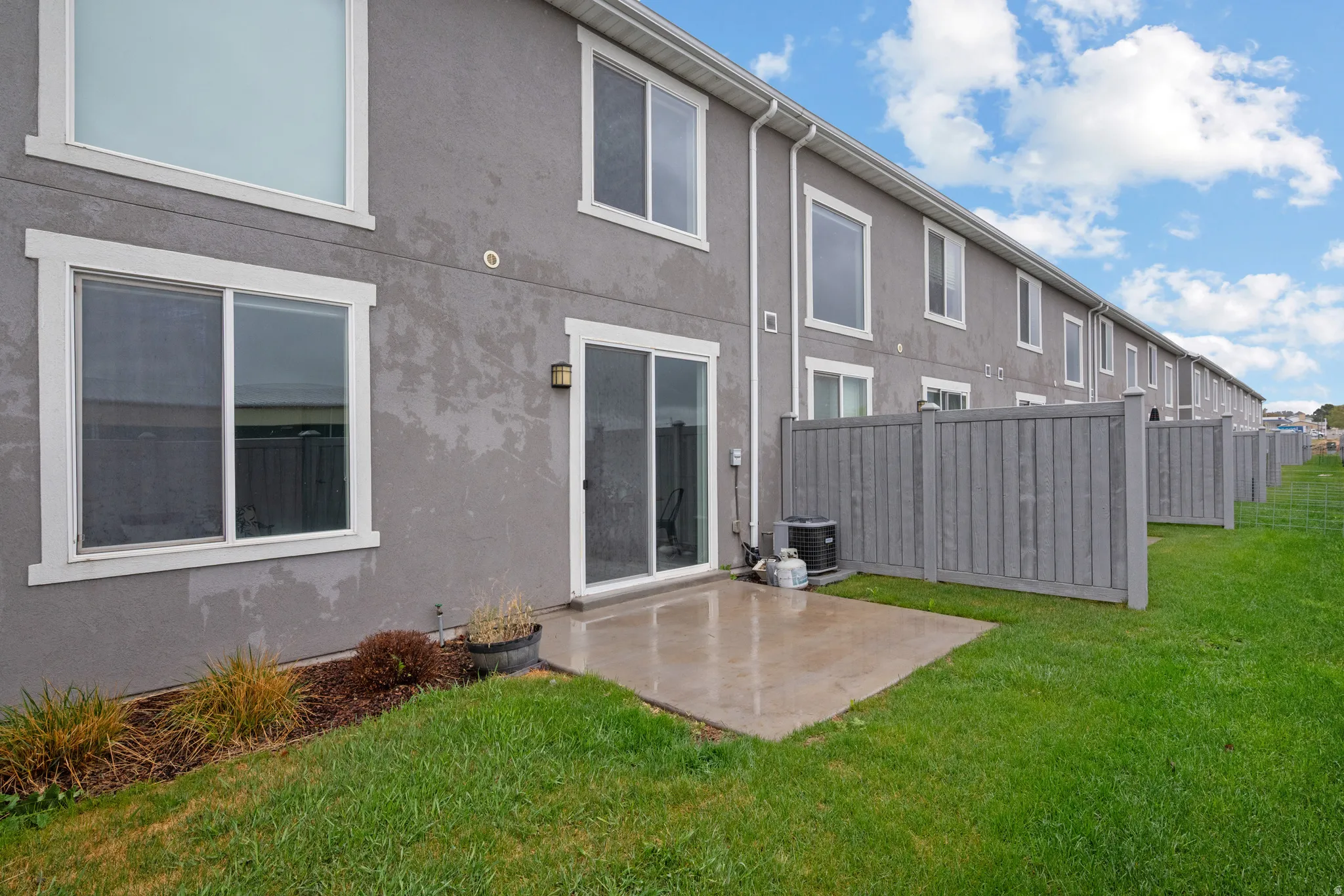 Rear view of house featuring a patio area and stucco siding
