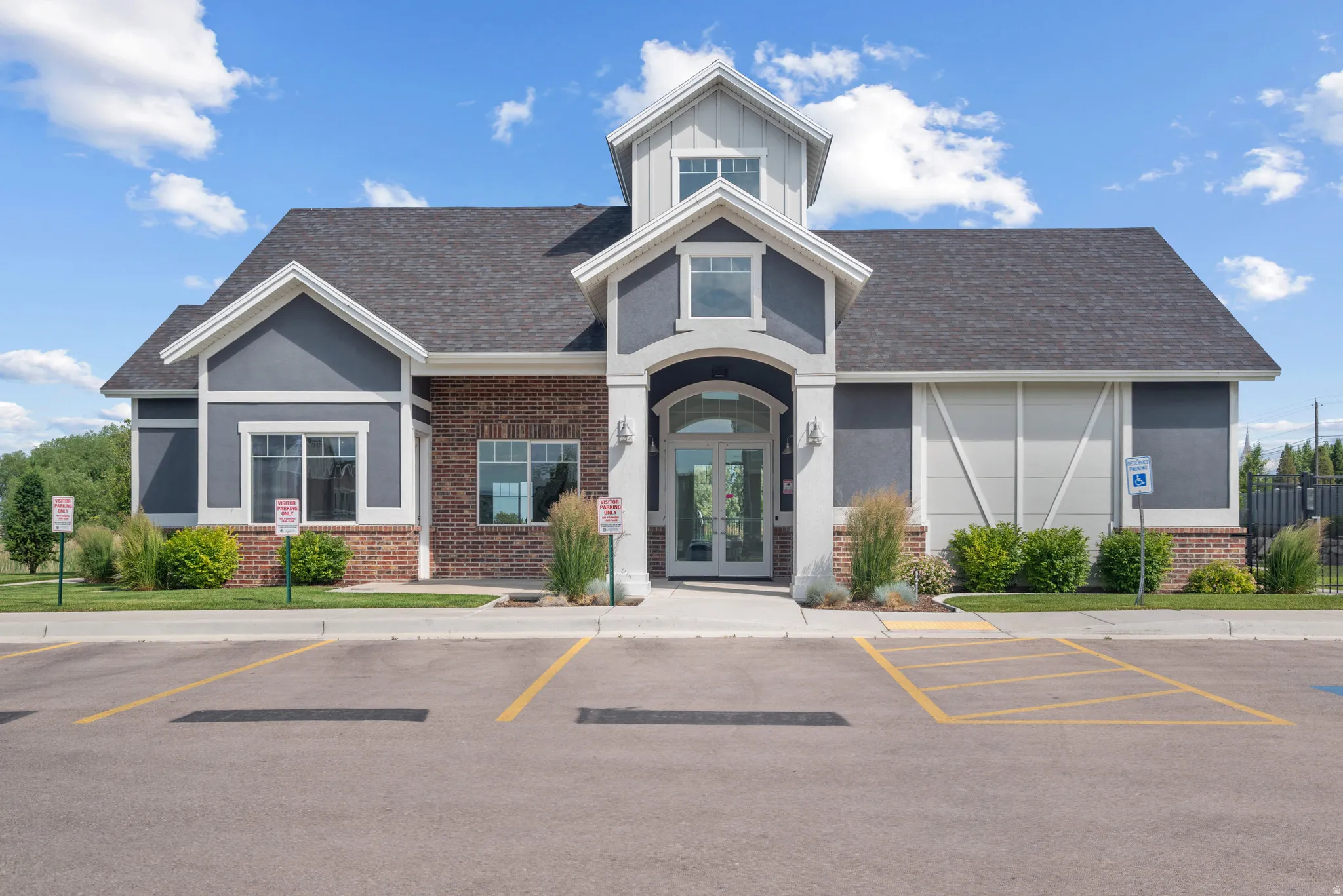 View of building exterior featuring uncovered parking
