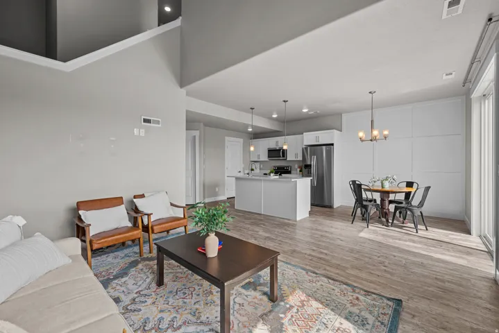 Living room featuring light wood-style flooring and a chandelier