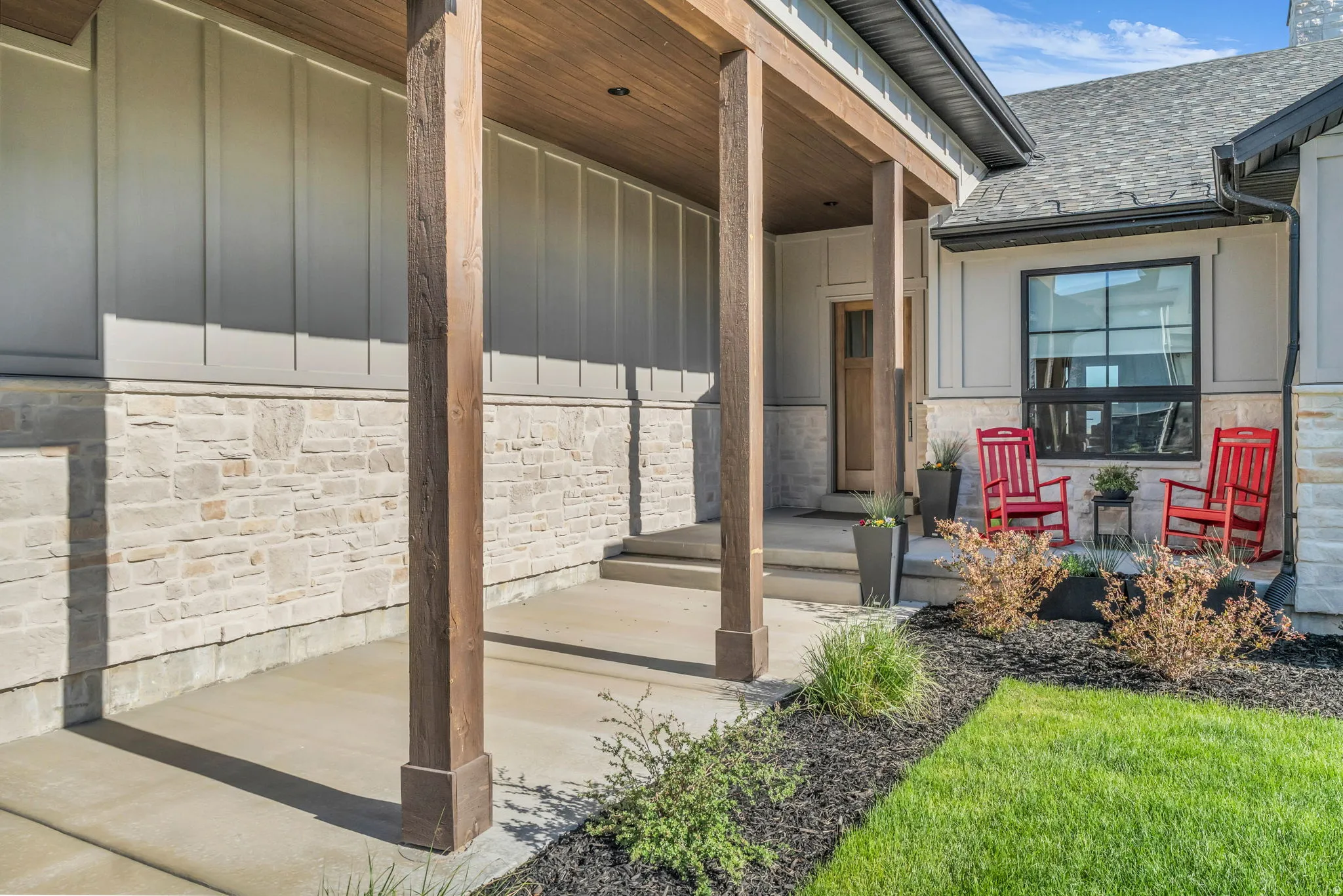 Covered front porch featuring wood-finish columns and a wood-finish ceiling