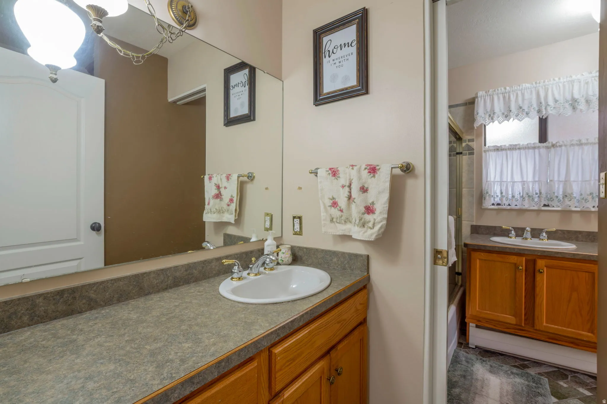 Full bathroom featuring vanity and enclosed tub / shower combo