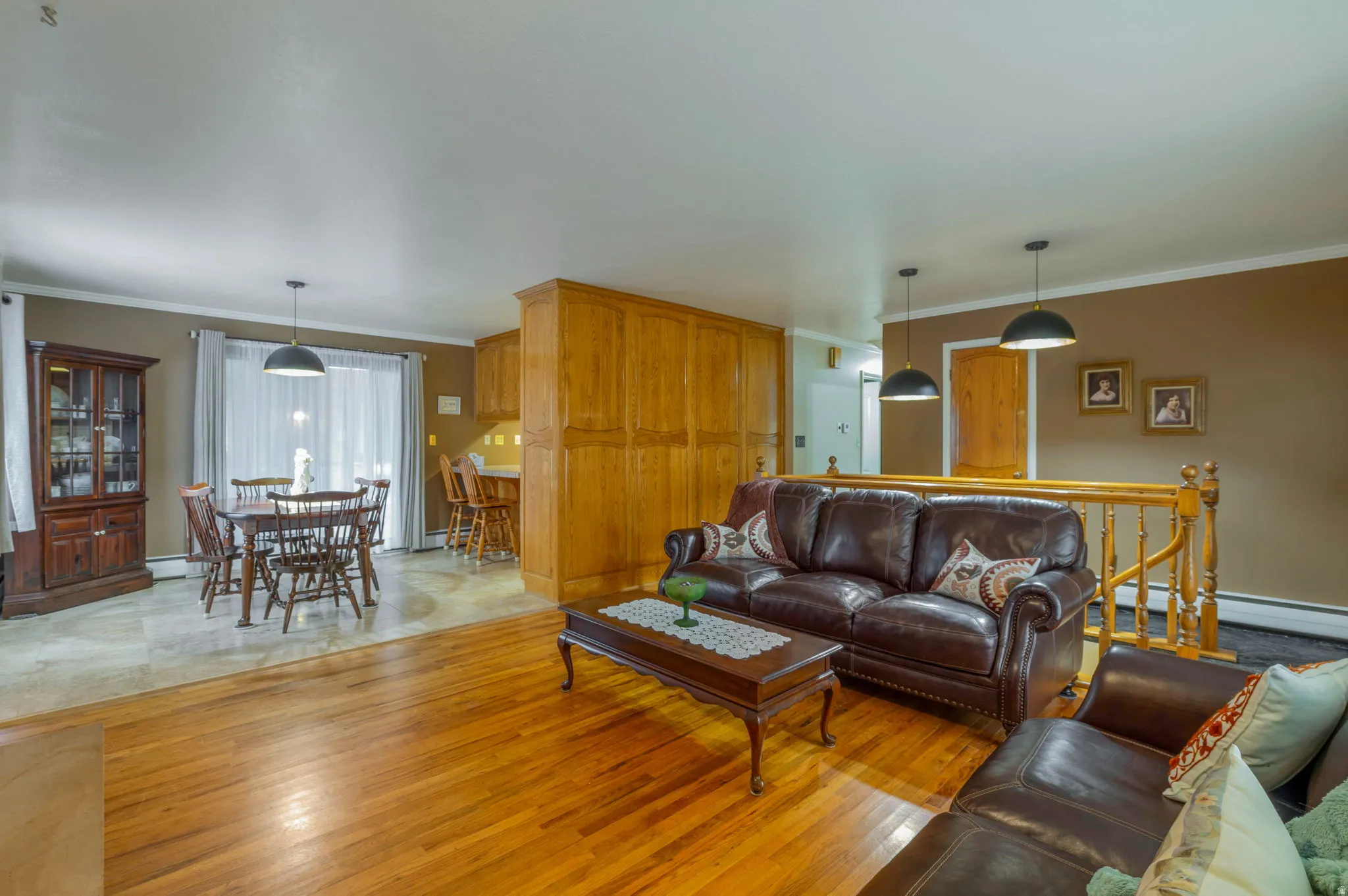 Living area featuring crown molding and light wood finished floors