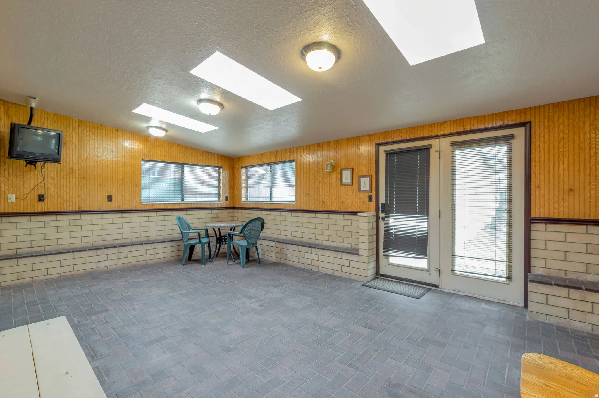 Unfurnished sunroom with a skylight and healthy amount of natural light