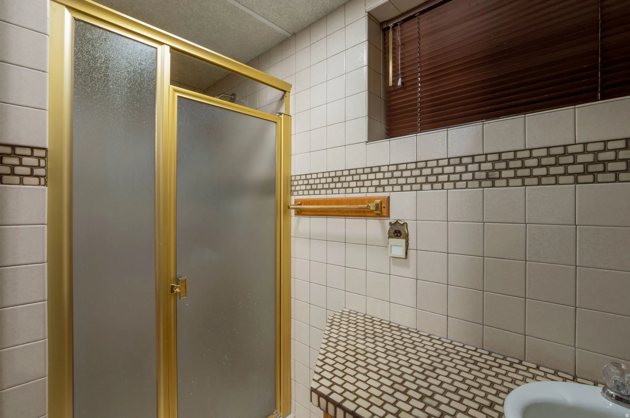 Bathroom featuring a stall shower, tile walls, and a bidet