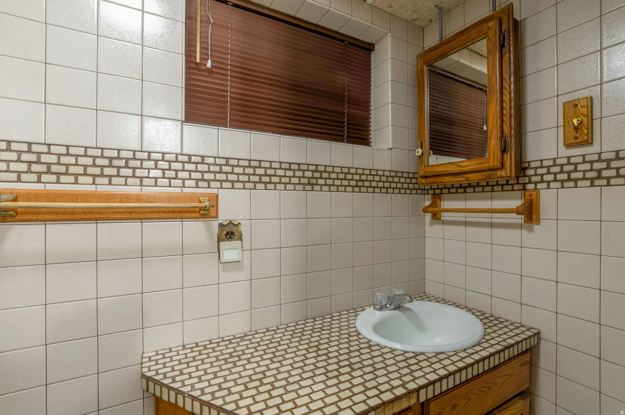Bathroom with vanity, tile walls, and decorative backsplash
