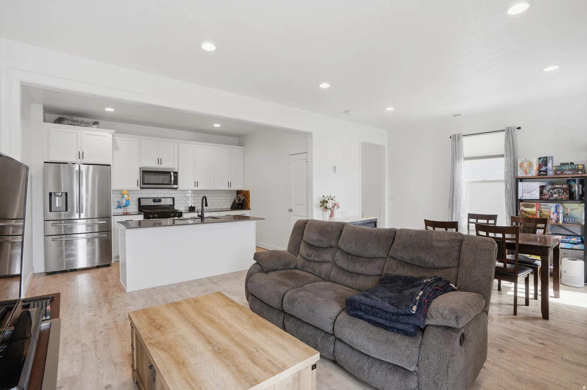 Living room with recessed lighting and light wood finished floors