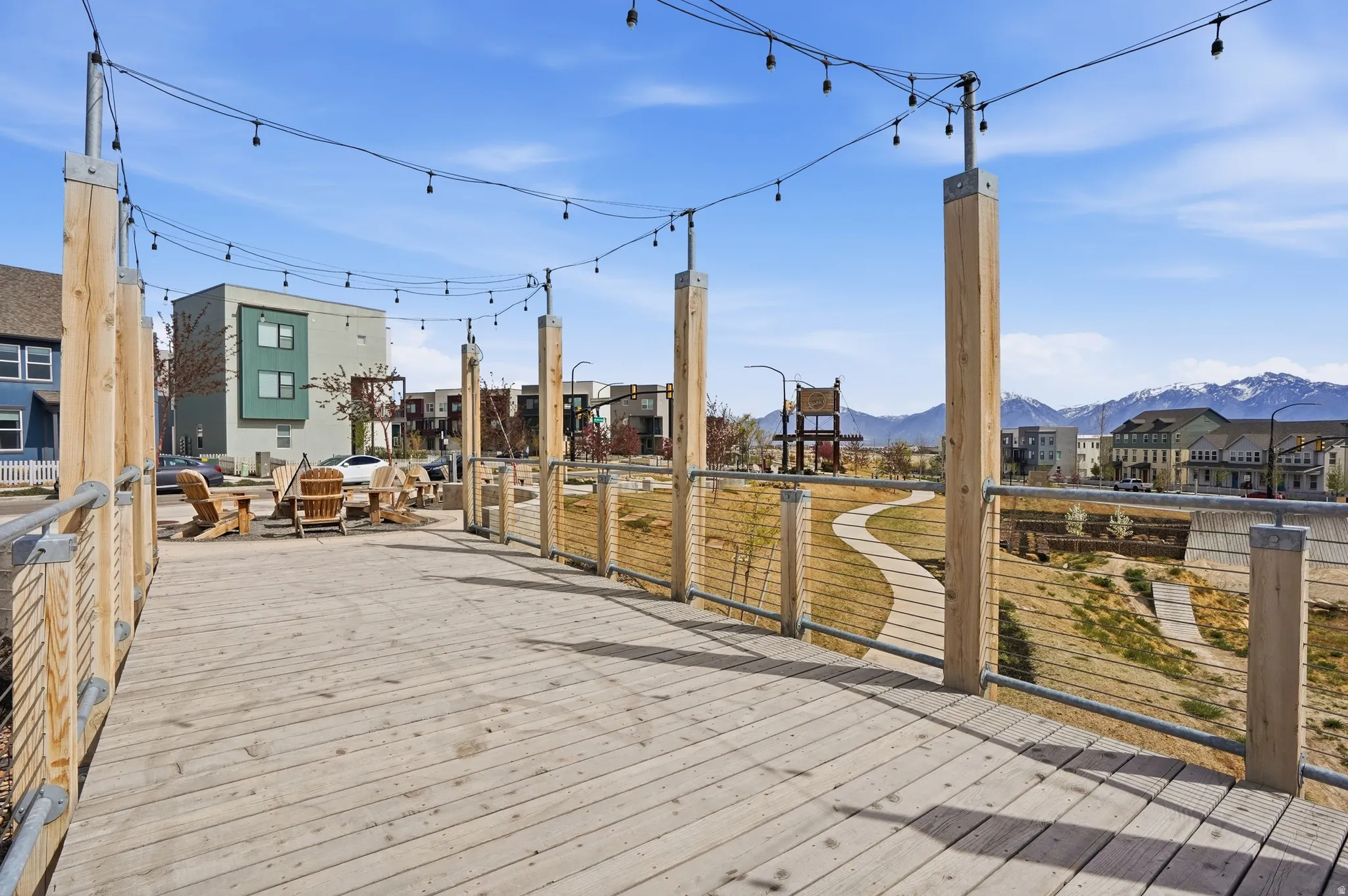 View of community outdoor fire pit and trails directly across the street