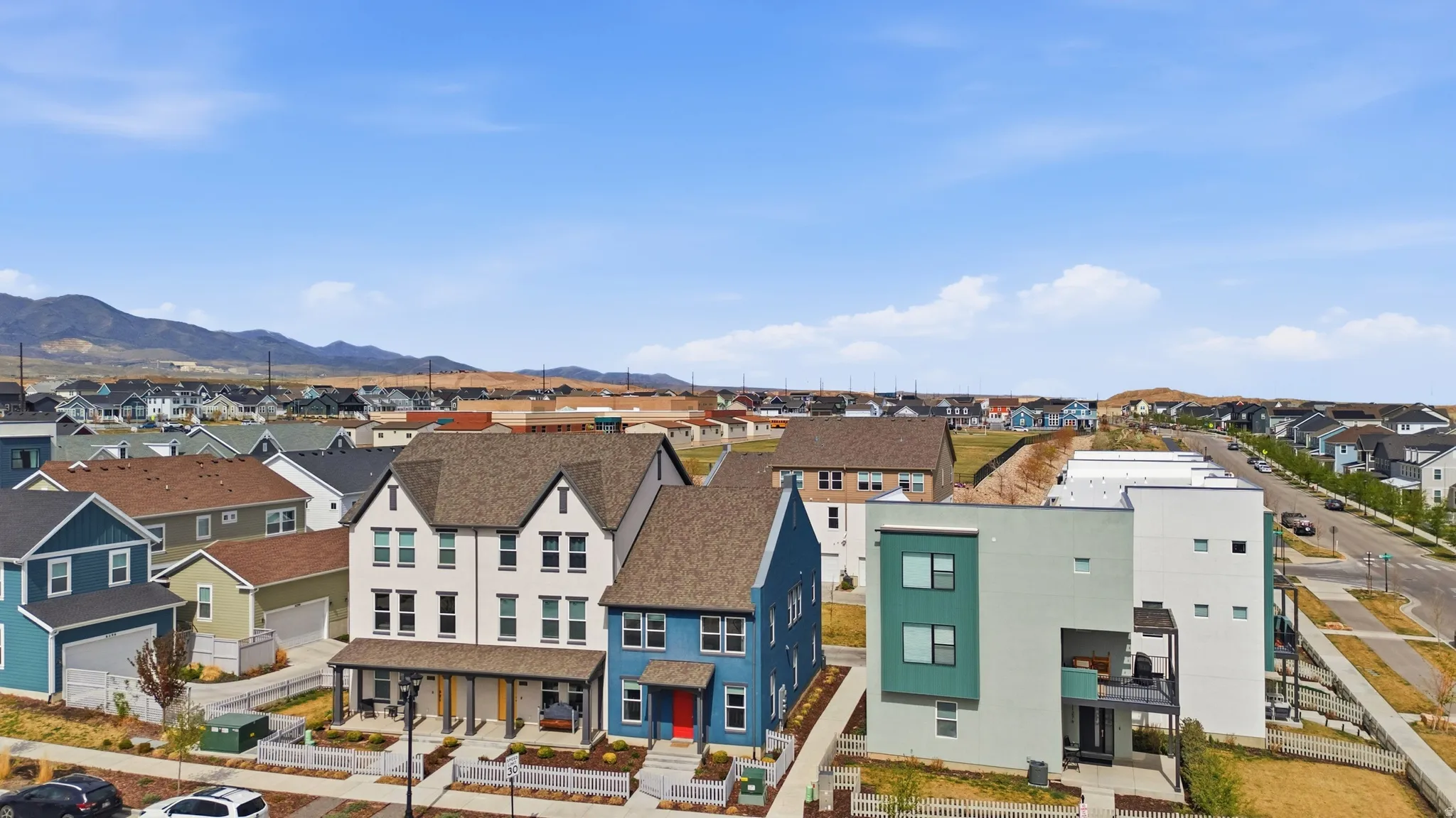 Aerial view of residential area featuring a mountainous background