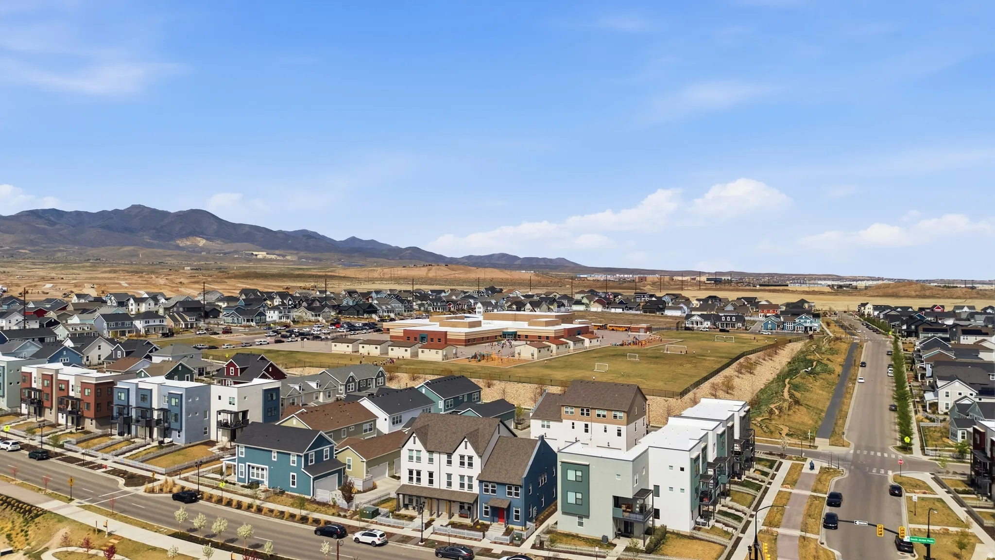Aerial perspective of suburban area featuring a mountain backdrop