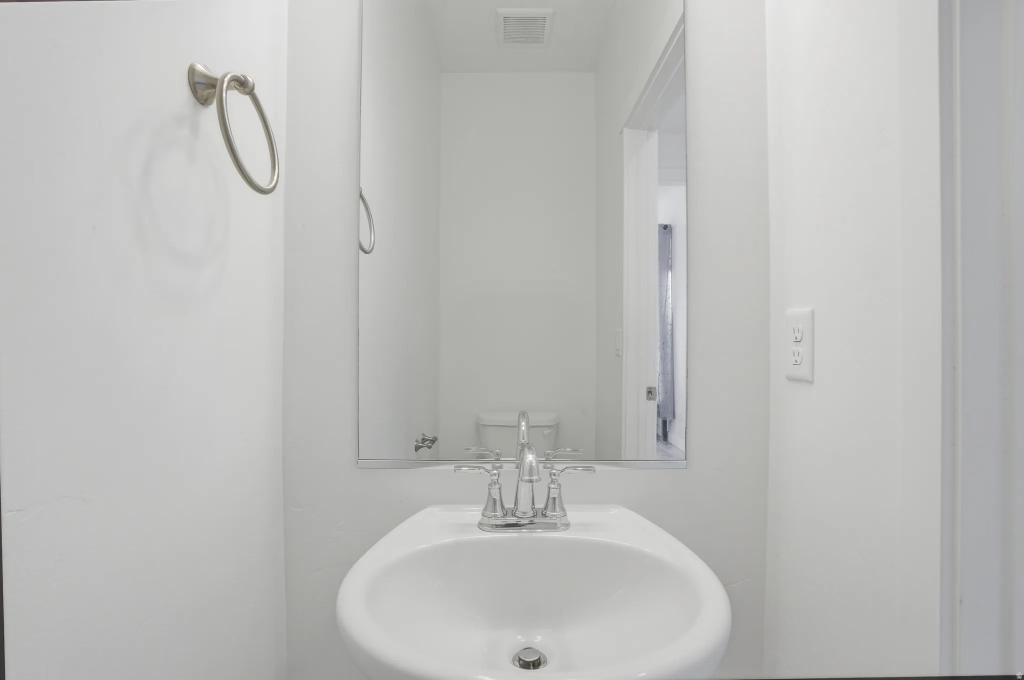 Half bathroom with a sink and toilet