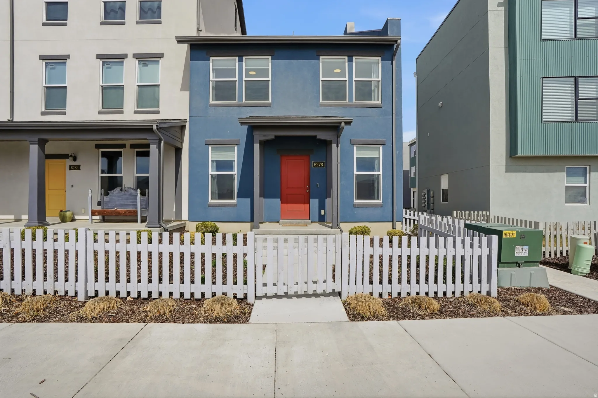 View of front of house featuring stucco siding and a fenced front yard