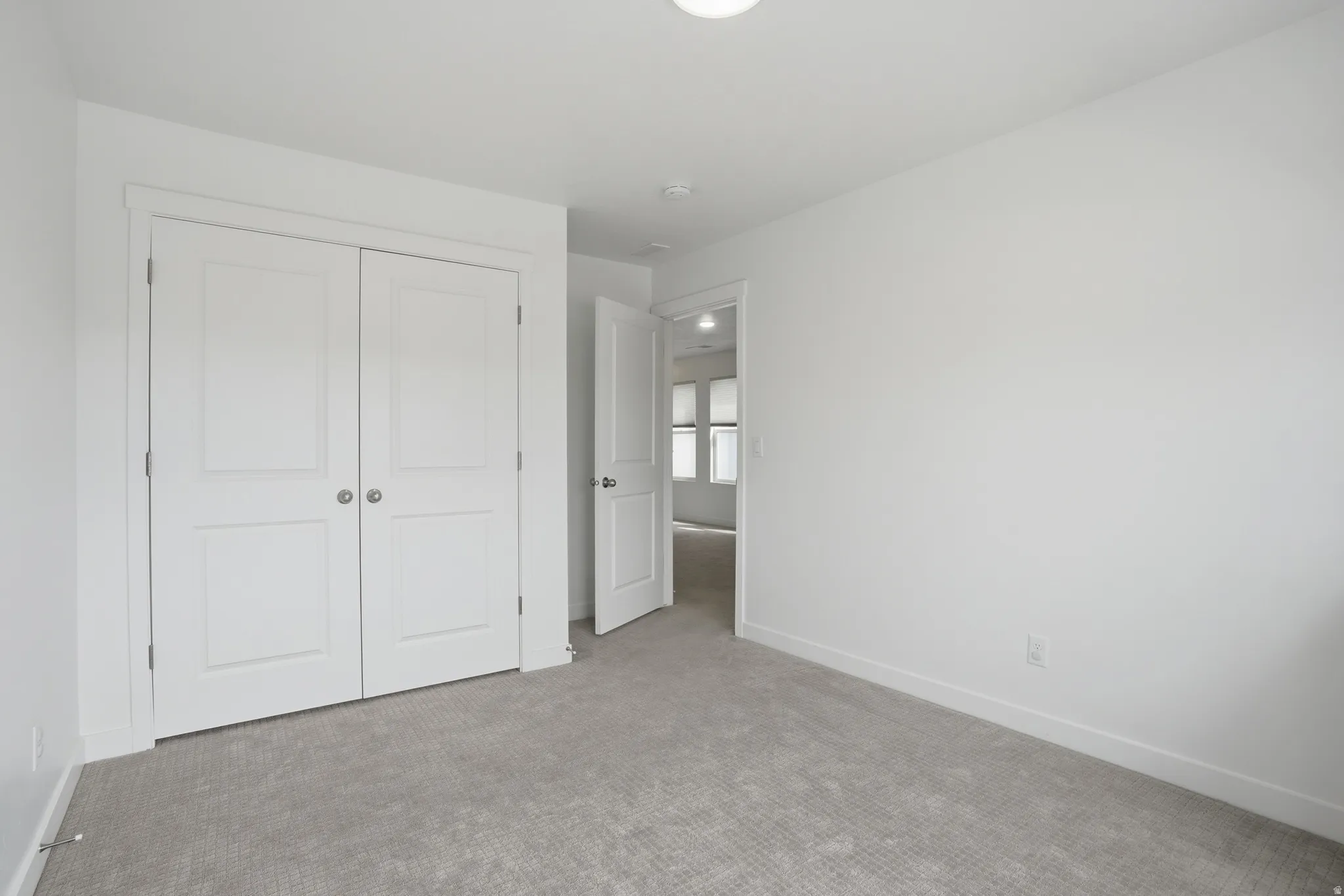 Third bedroom with carpet floors and a closet