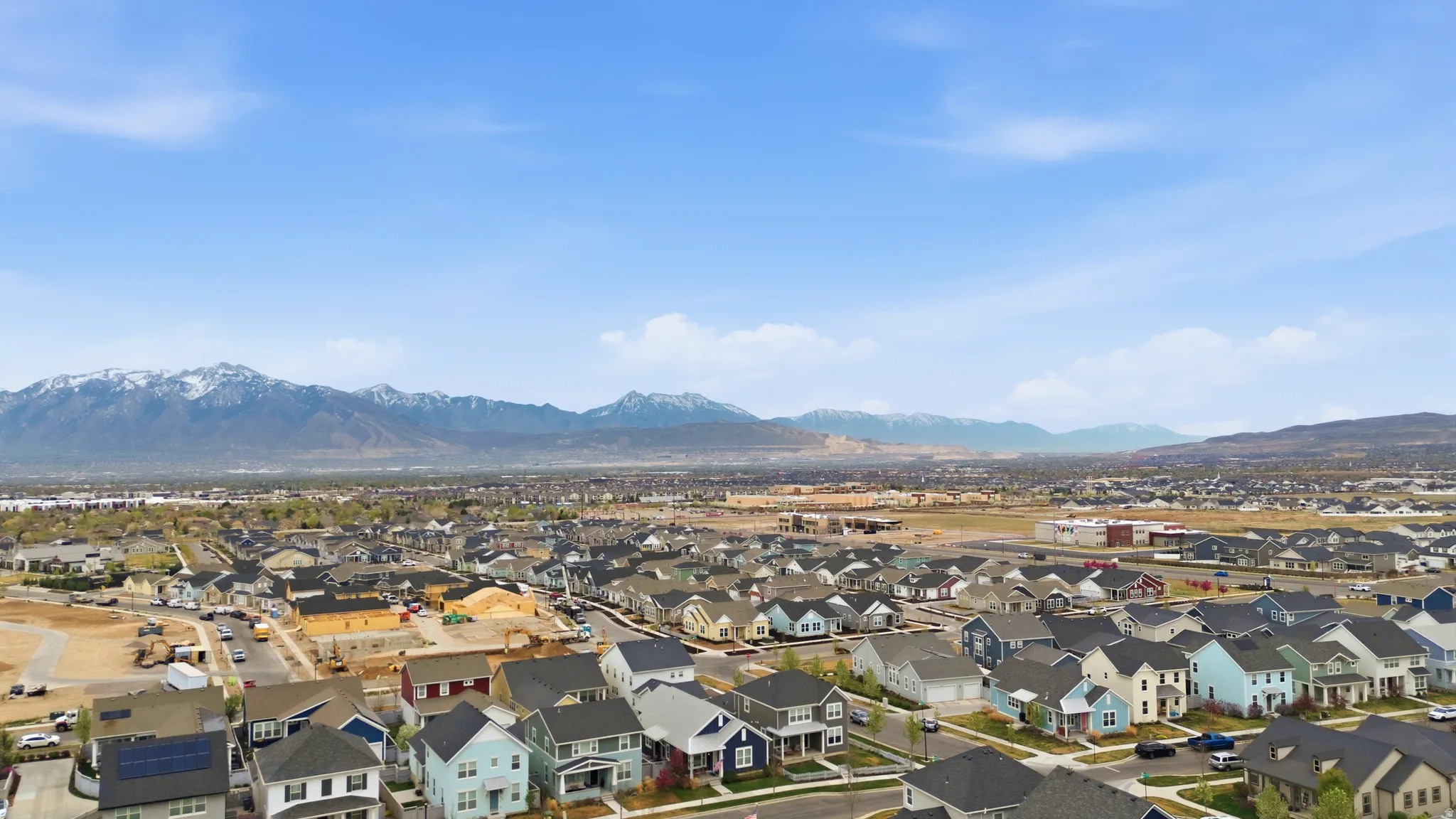 Aerial perspective of suburban area featuring a mountain backdrop