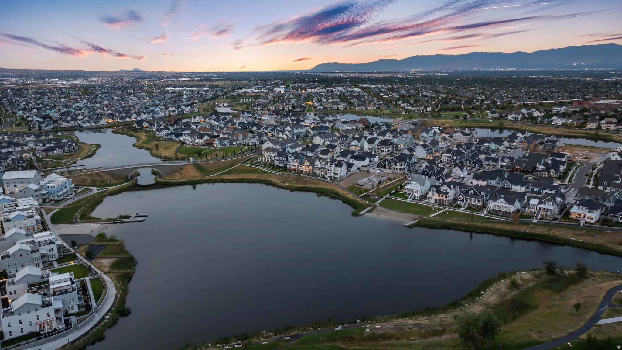 Aerial view at dusk of a residential view and a water and mountain view