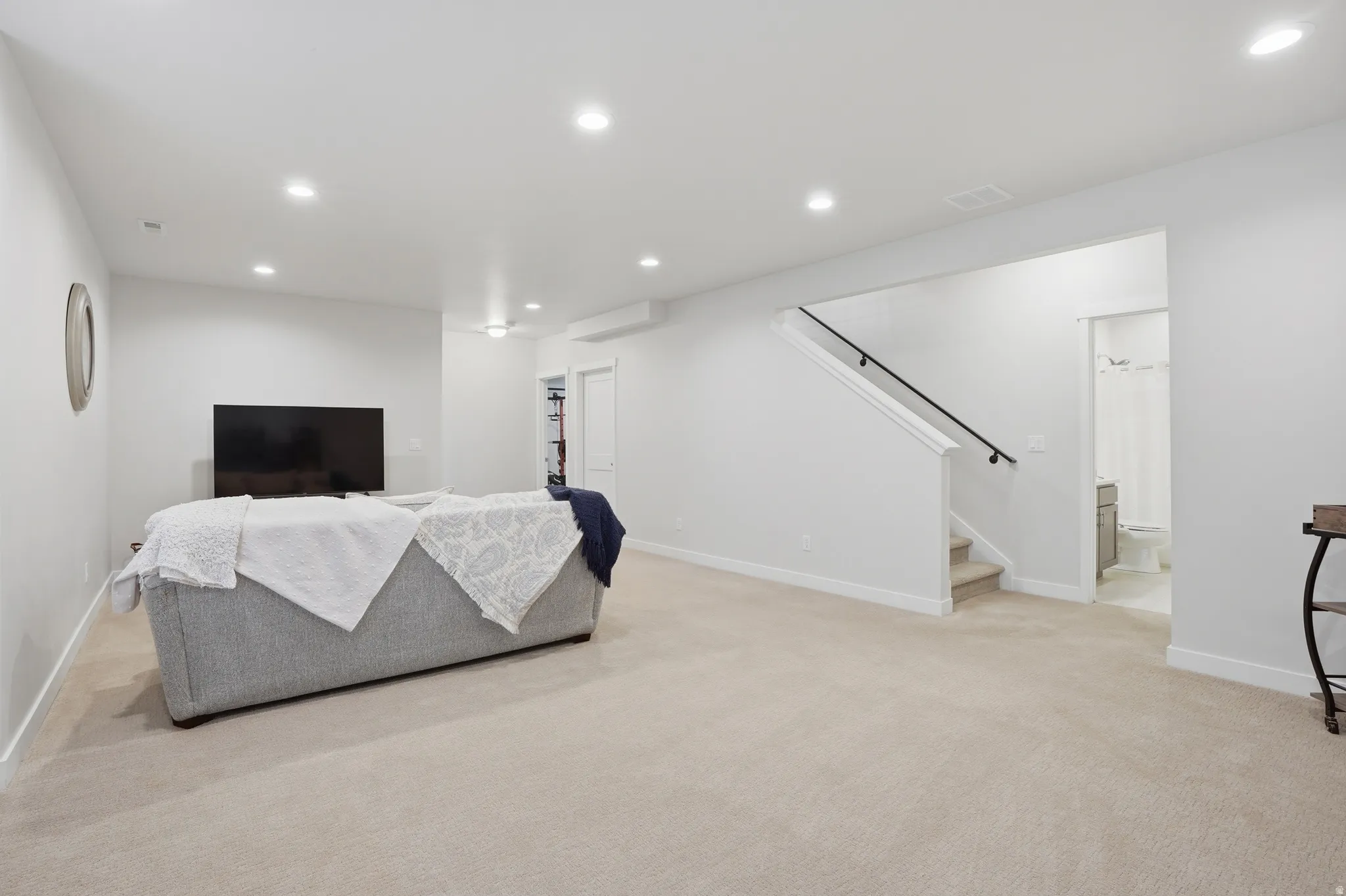 Living room featuring recessed lighting and light carpet