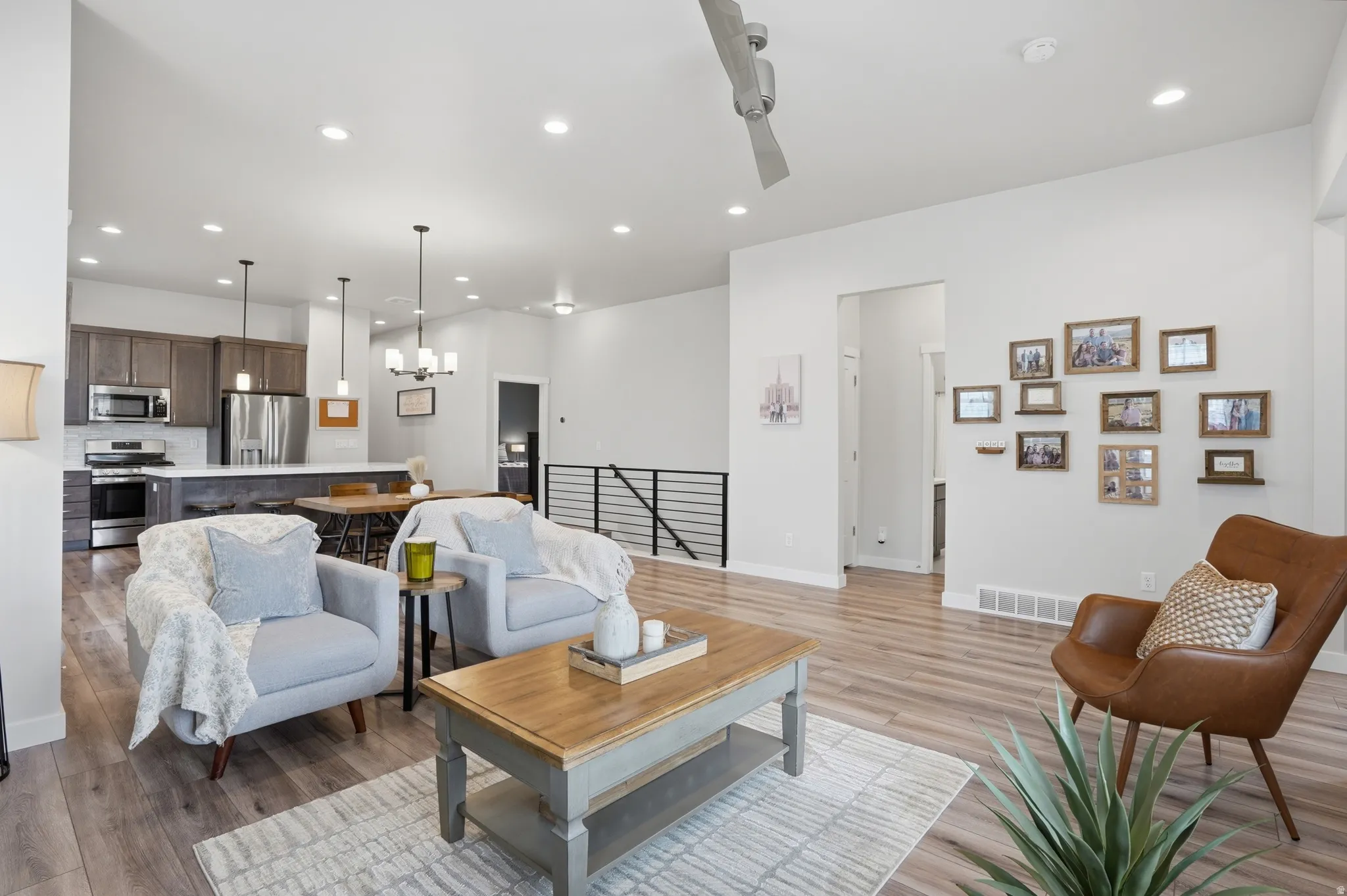 Living room featuring light wood finished floors and suspended lighting
