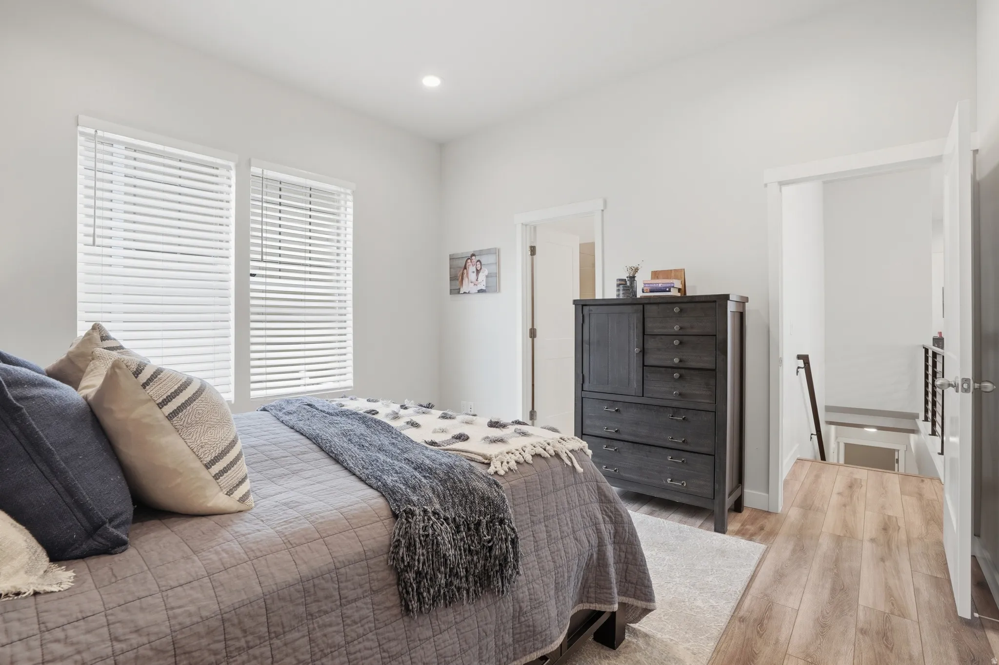 Bedroom with wood finished floors and recessed lighting