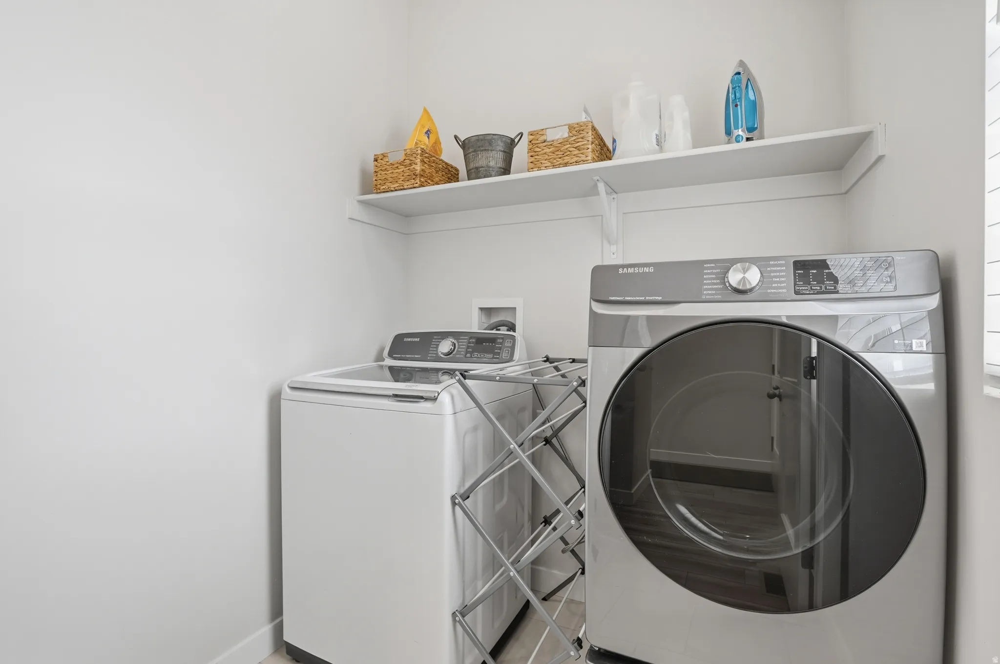 Laundry area with washing machine and dryer and baseboards