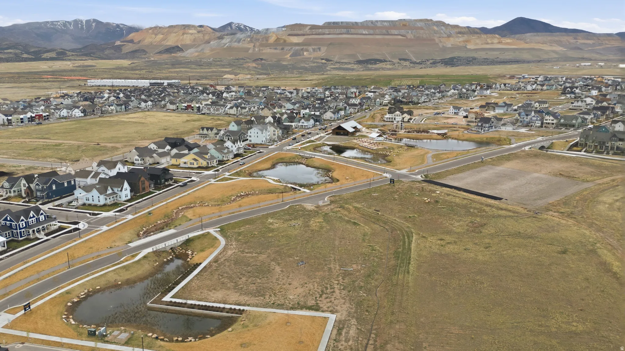 Aerial overview of property's location featuring nearby suburban area and a water and mountain view