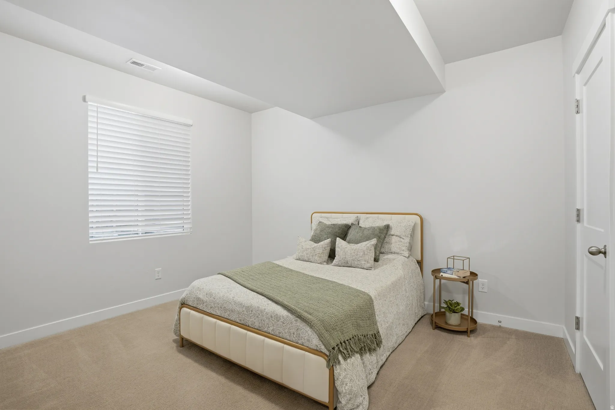 Bedroom with light carpet
