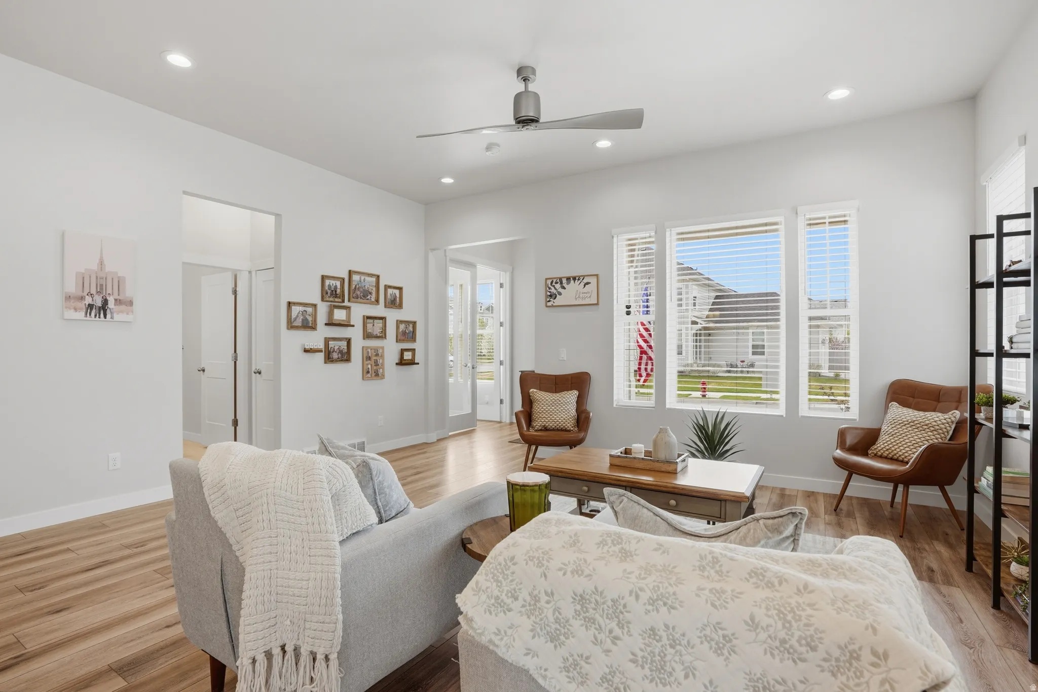 Living area featuring ceiling fan, light wood-style floors, plenty of natural light, and recessed lighting