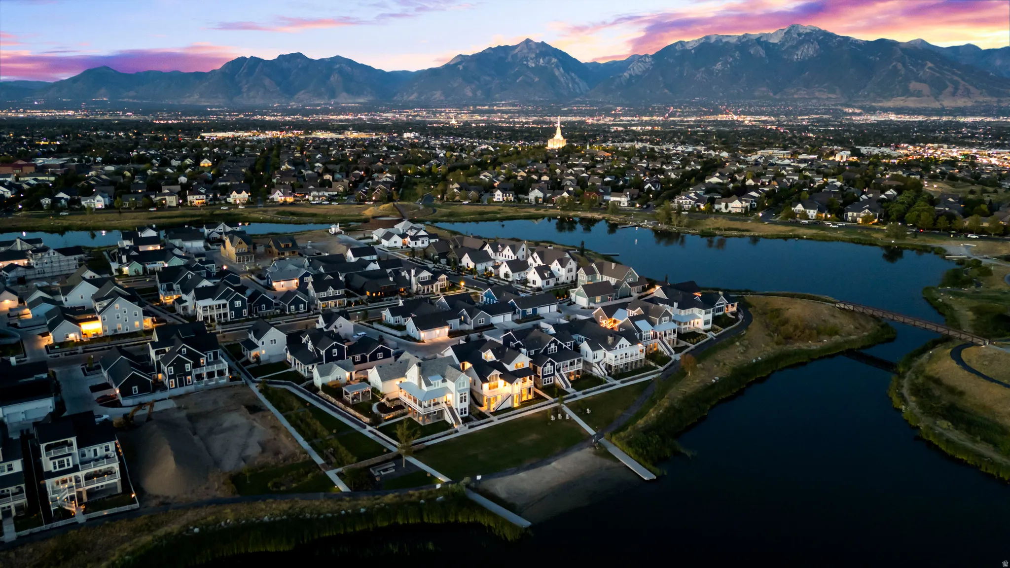 Aerial view at dusk of a residential view and a water and mountain view