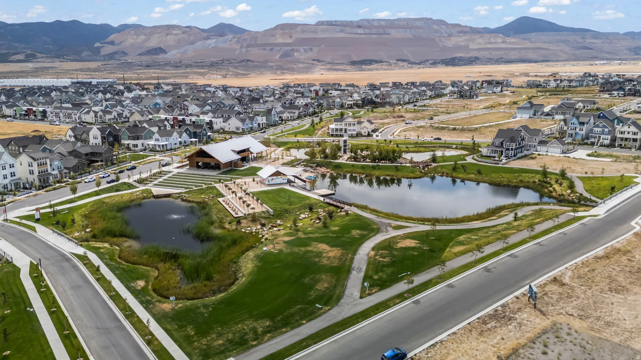Aerial view of property's location with nearby suburban area and a water and mountain view