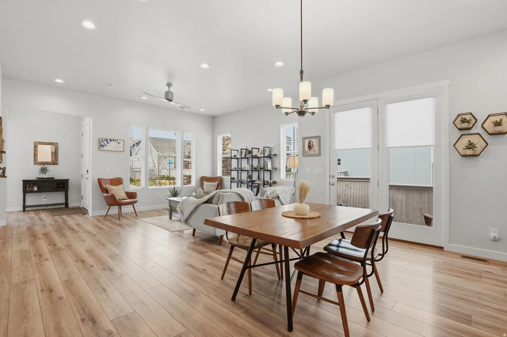 Dining room featuring light wood-style floors, ceiling fan, and hanging lights