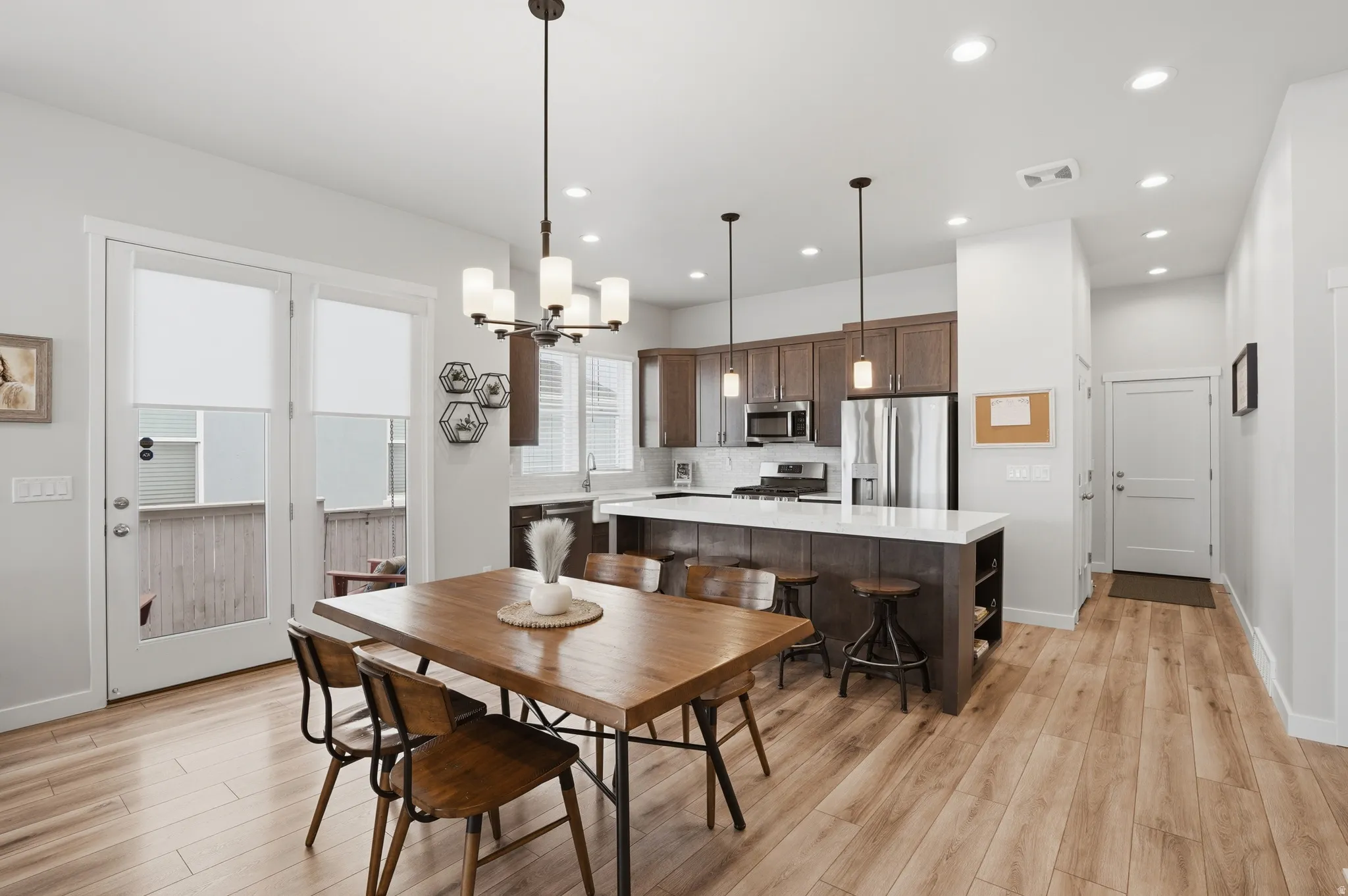 Dining room featuring light wood-style floors and suspended lighting