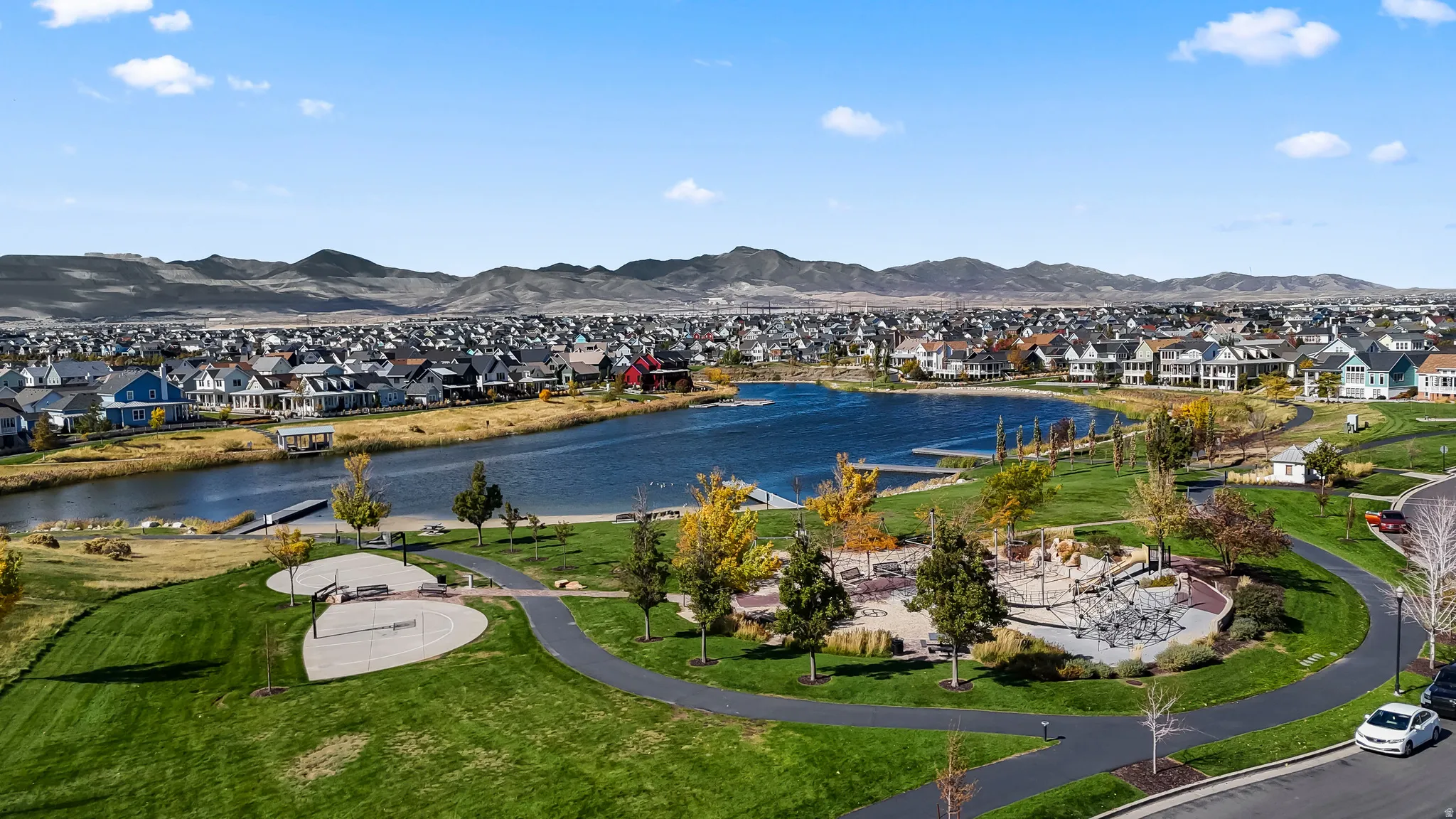 Water view with nearby suburban area and a mountainous background
