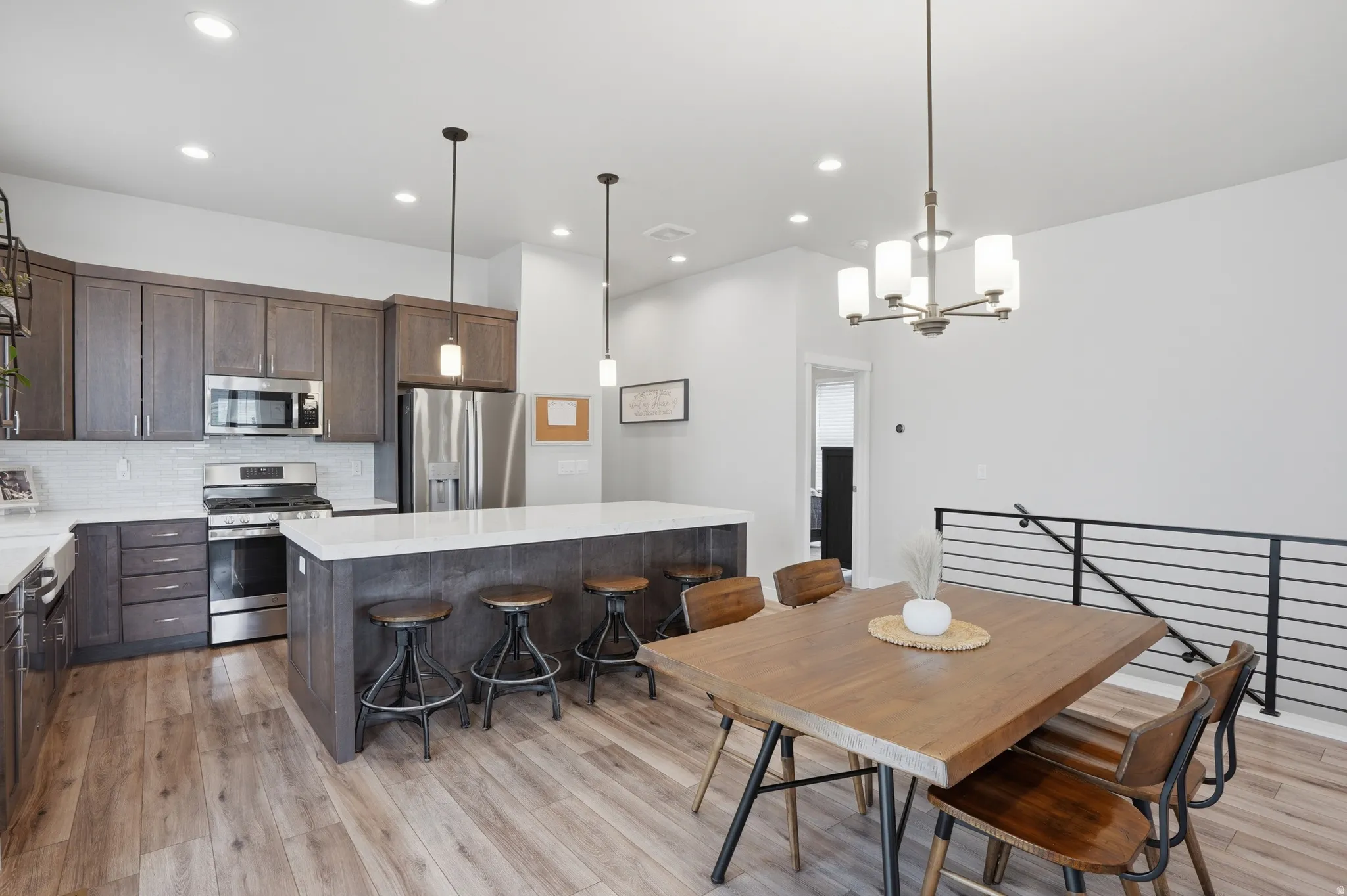 Dining space featuring light wood-style flooring and hanging lights