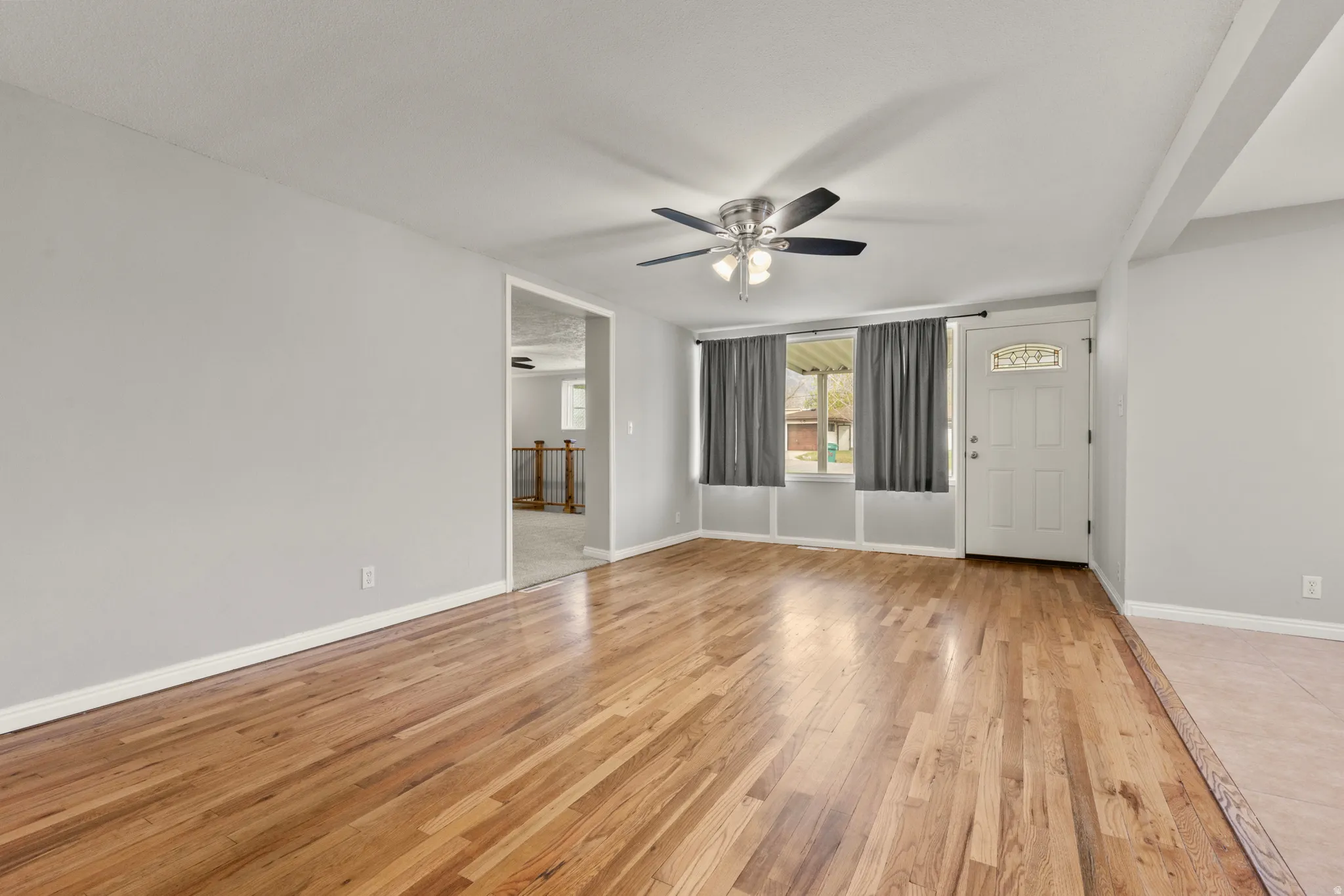 Unfurnished room with light wood-style flooring and a ceiling fan