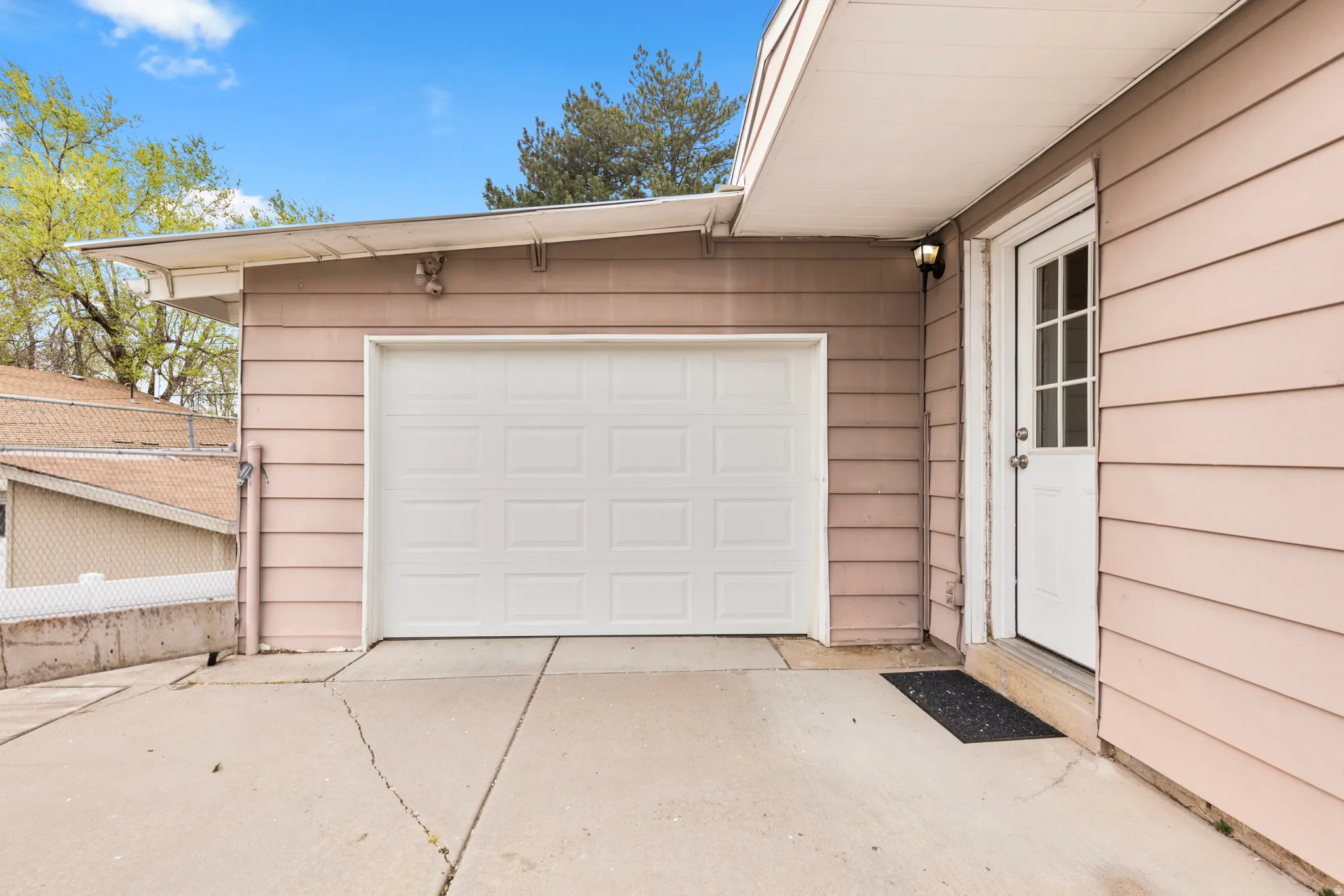 Garage featuring concrete driveway