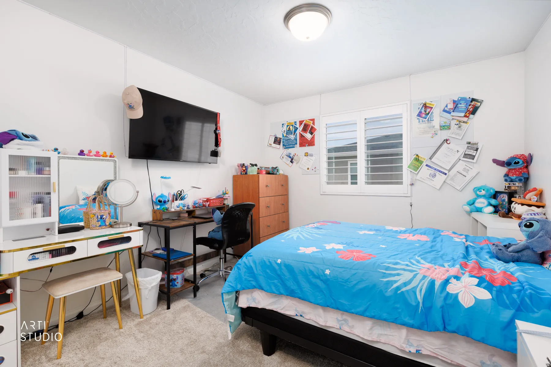 Bedroom featuring light colored carpet