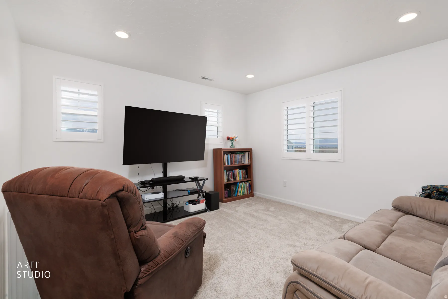 Living room featuring light colored carpet and recessed lighting