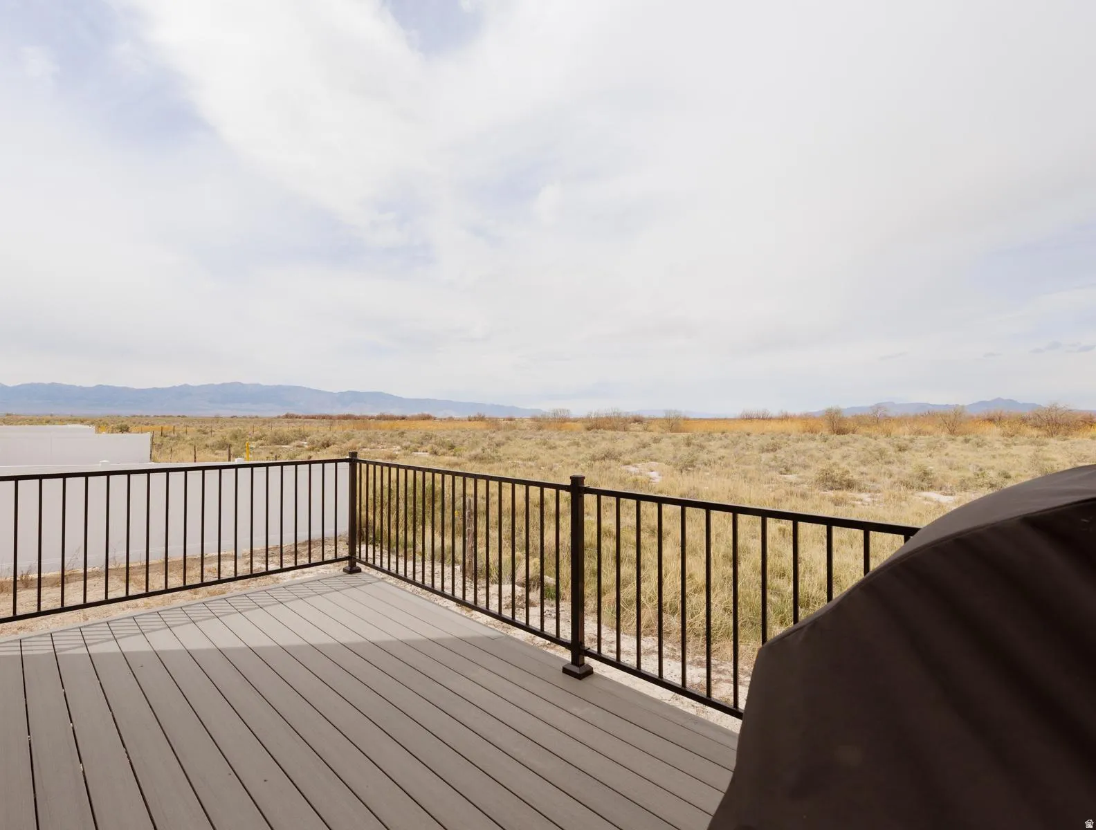 Wooden terrace featuring grilling area and a mountain view