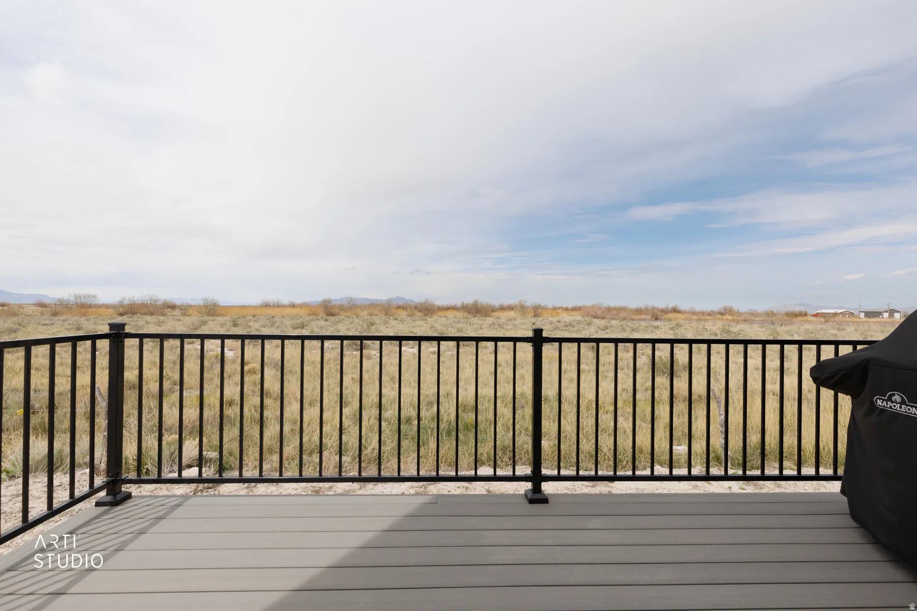 Wooden terrace featuring a grill