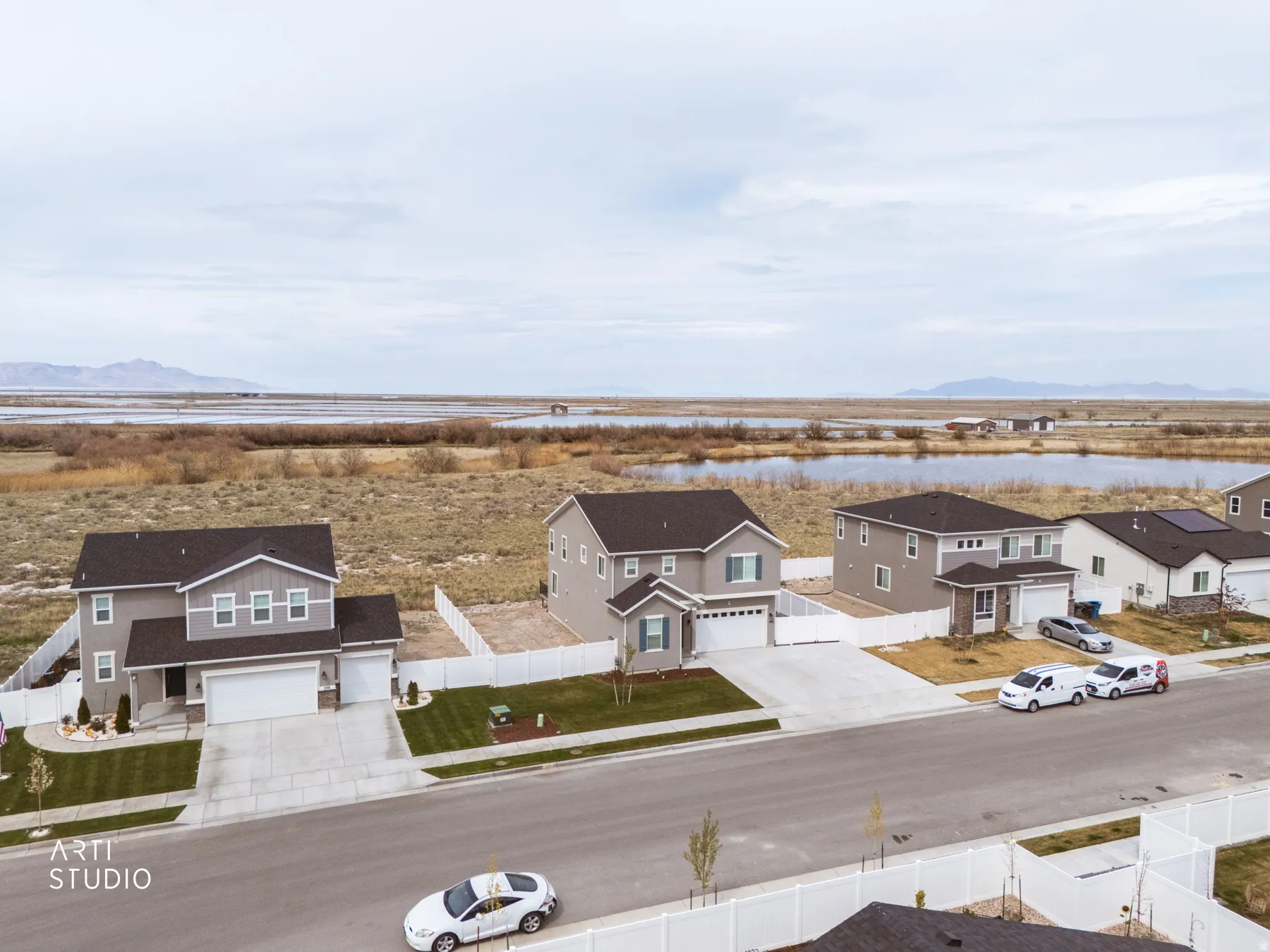 Aerial perspective of suburban area with a water and mountain view